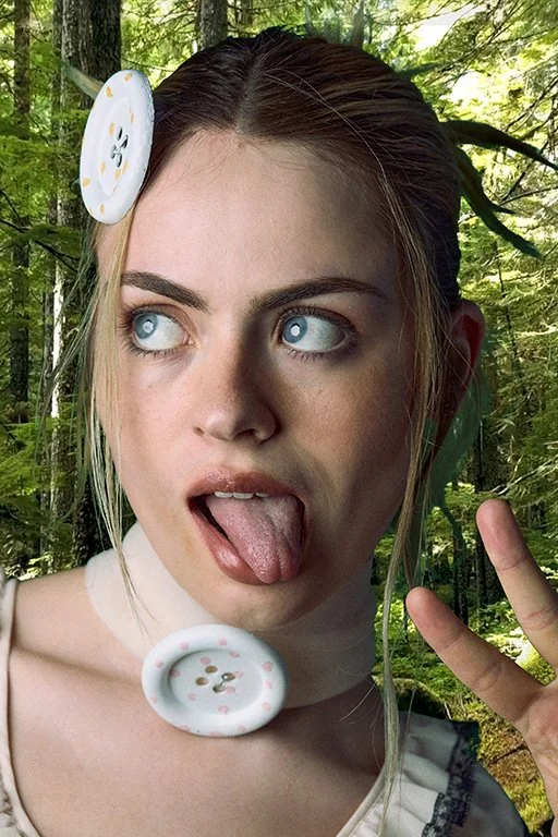 Portrait of a blonde woman against a dark background looking upward with a neutral expression, wearing a pearl necklace with a silver pendant and a white lace top. Fashion