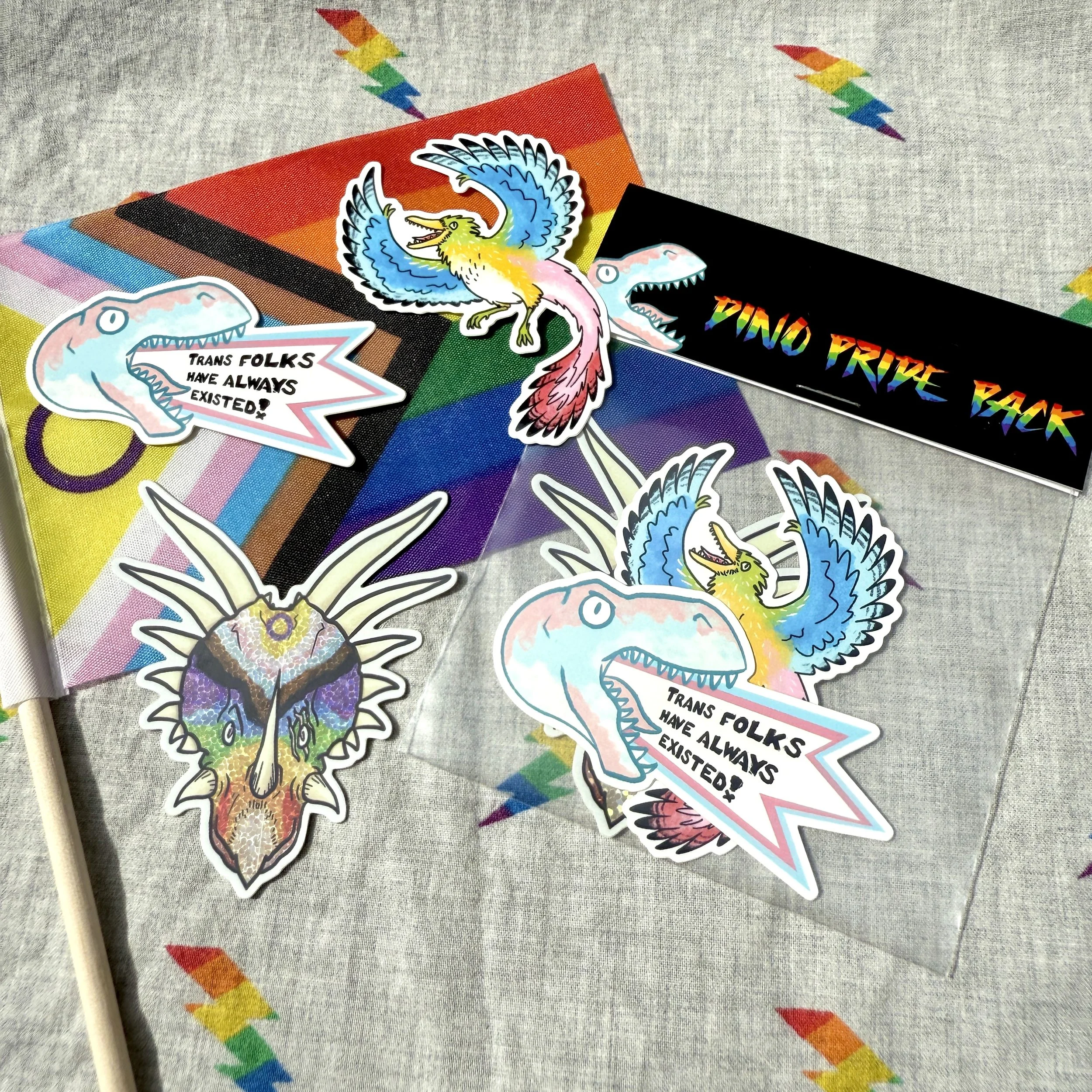 A set of dinosaur stickers with a queer pride theme