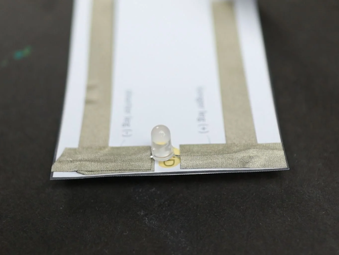 the easy paper circuit with an LED connected to it. Close-up of the LED.