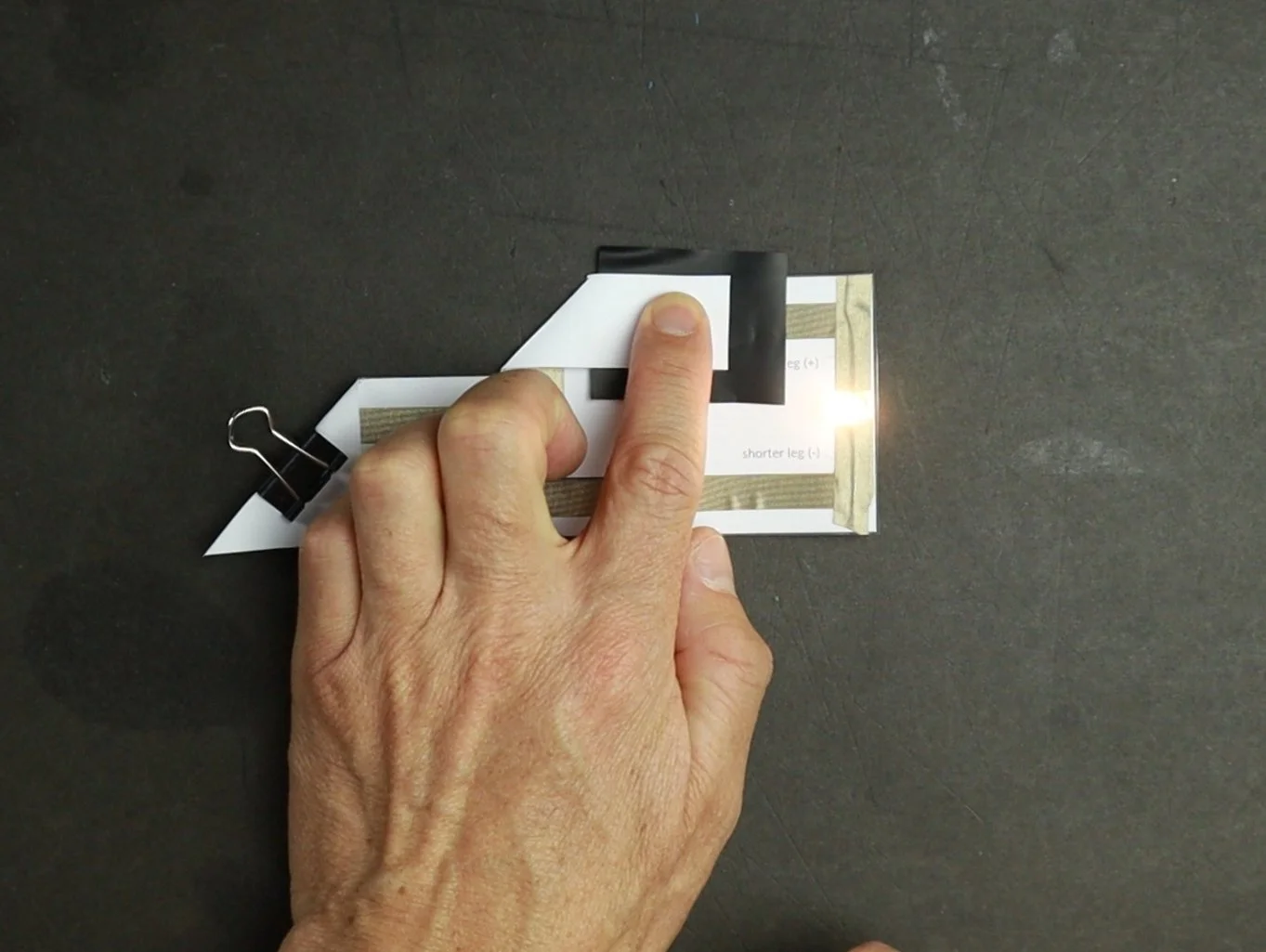 Easy circuit template with light up LED. The fold over DIY switch is improved with a pressure sensitive black sheet. More pressure make the LED light up brighter.