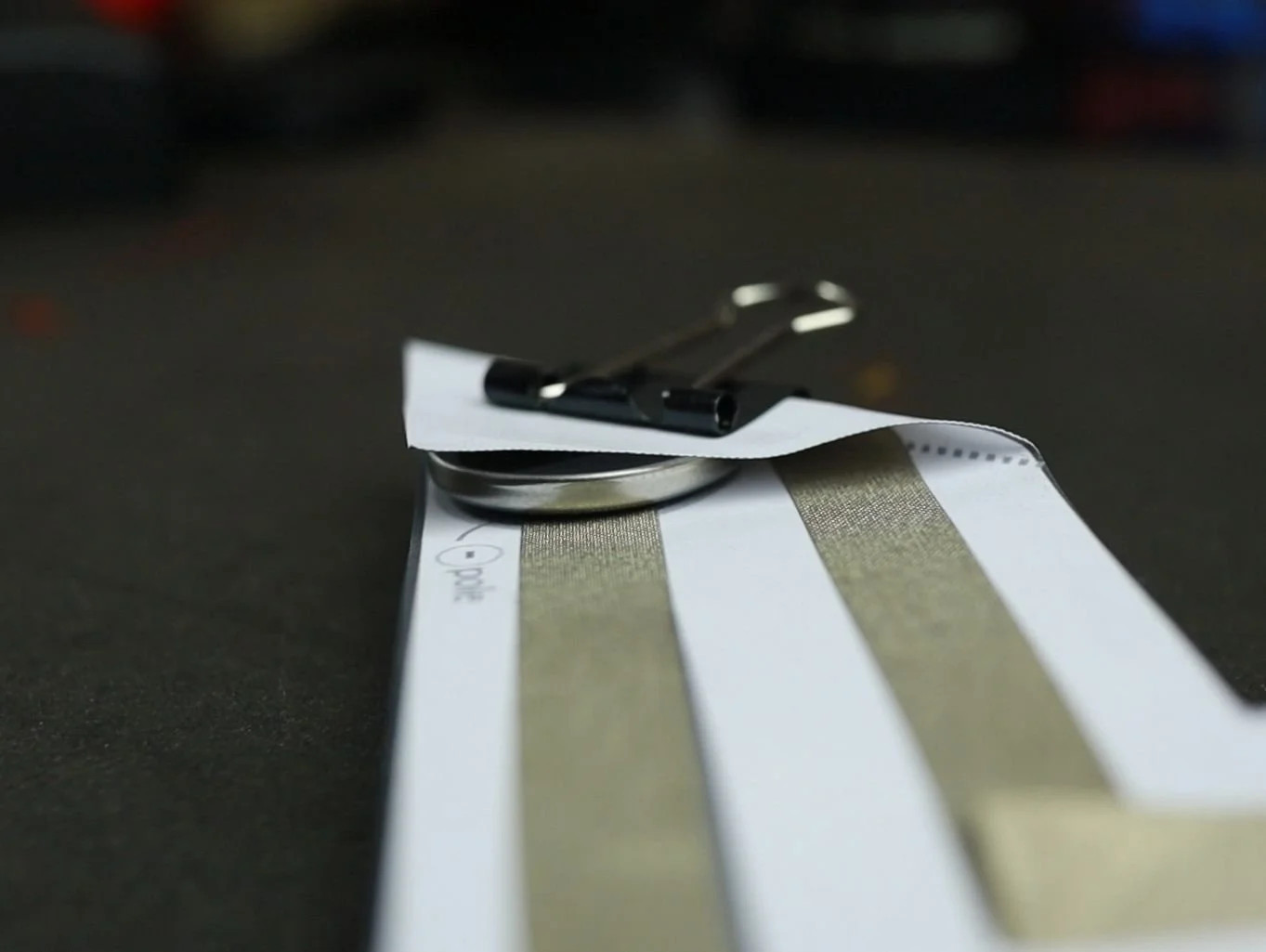 the easy paper circuit with a binder clip securing the button cell
