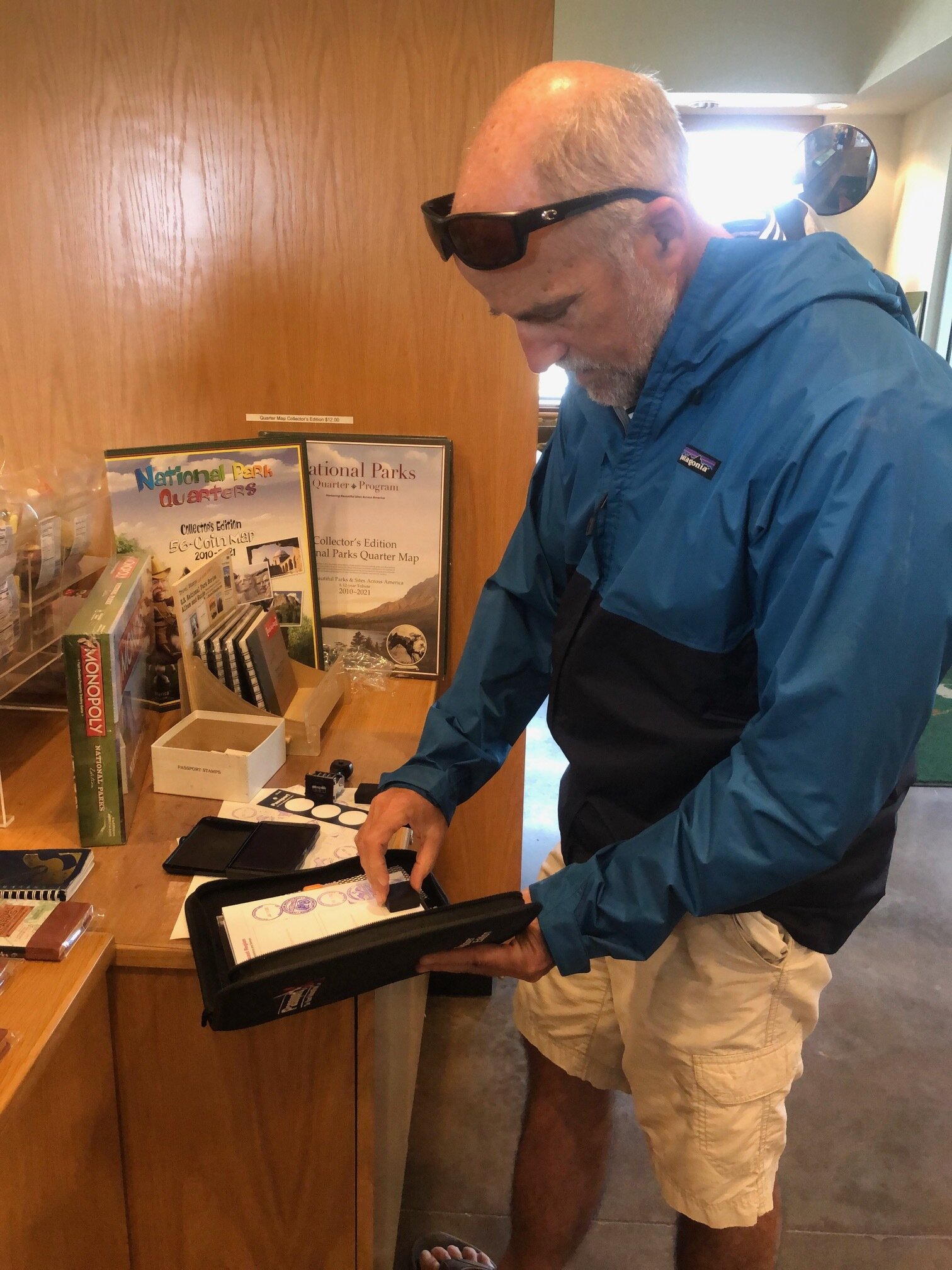  Craig stamping our National Parks Passport book at Big Cypress National Preserve in Ochopee, Florida. Here we saw a large alligator swimming down the river as the park ranger spoke. Our National Parks book was a gift from our dear friends and neighb