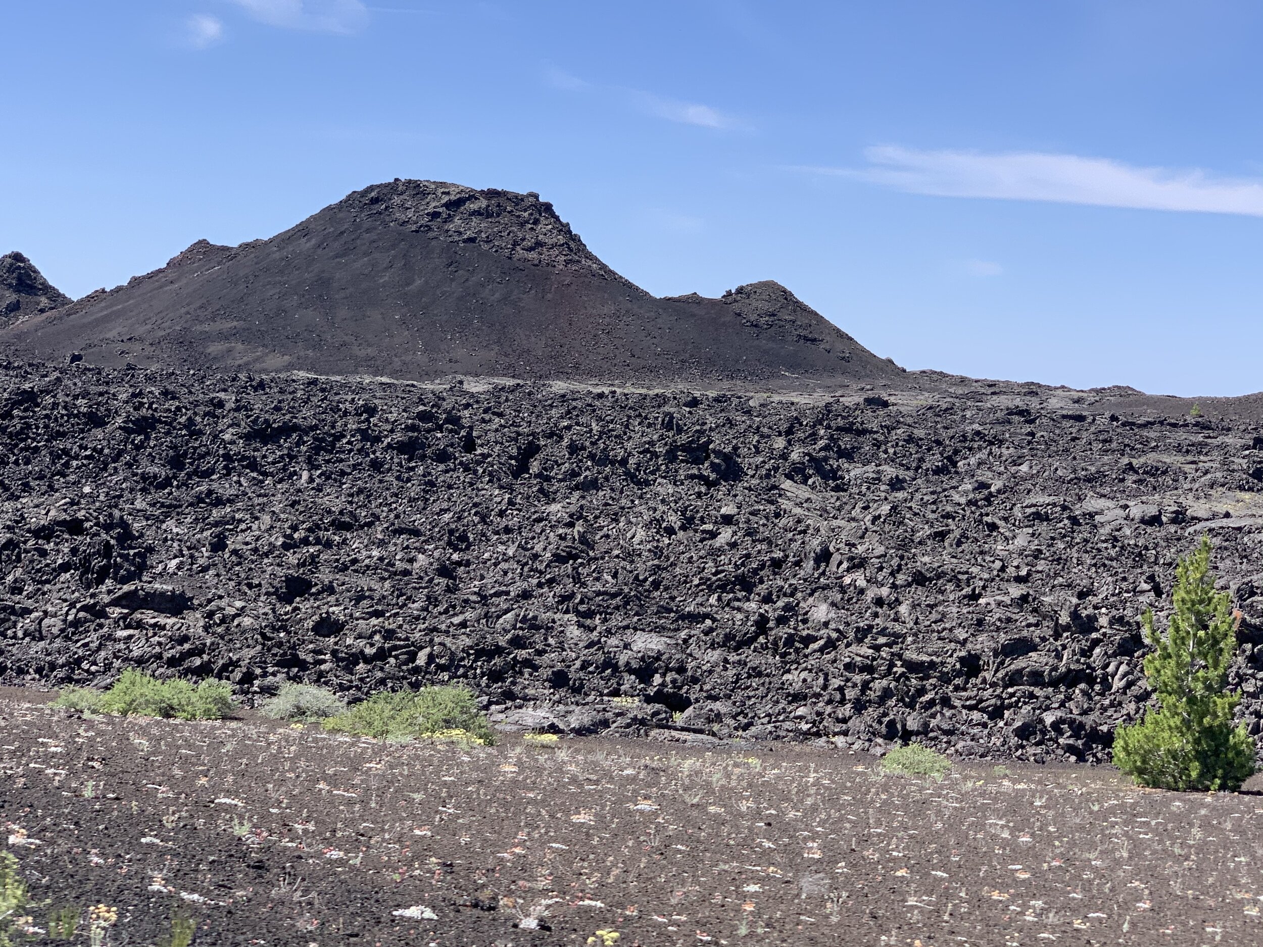  En route to our next destination, we stopped at Craters of the Moon National Monument &amp; Preserve. This 1,117-square mile area in central Idaho was created by the lava flow of several volcanoes that erupted between 15,000 and 2,000 years ago. Thi