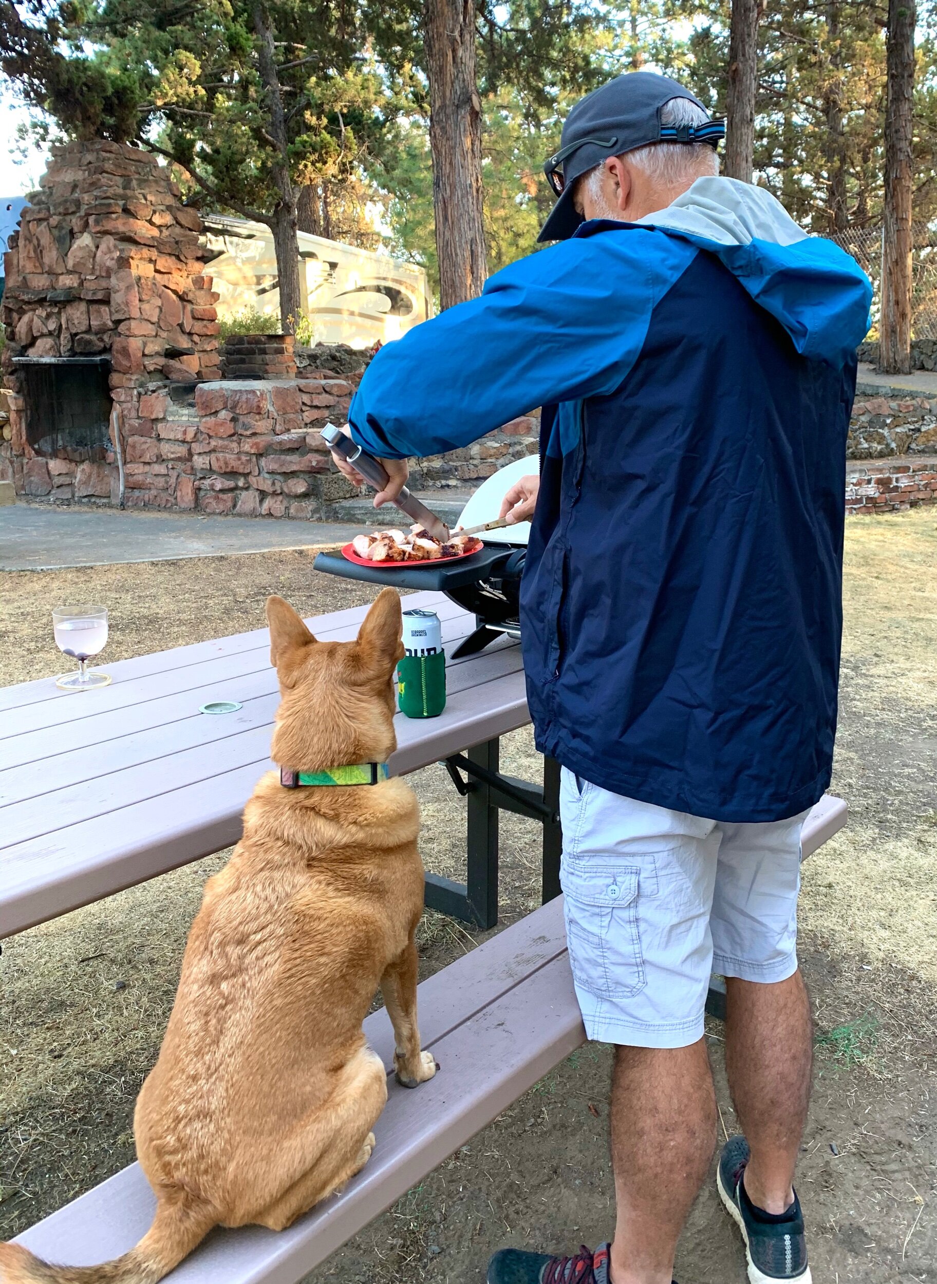  We enjoyed taking it easy for a few days in the quaint town of Bend .  Here, Clay waits for Craig to finish cooking what he believes to be “his” dinner. 