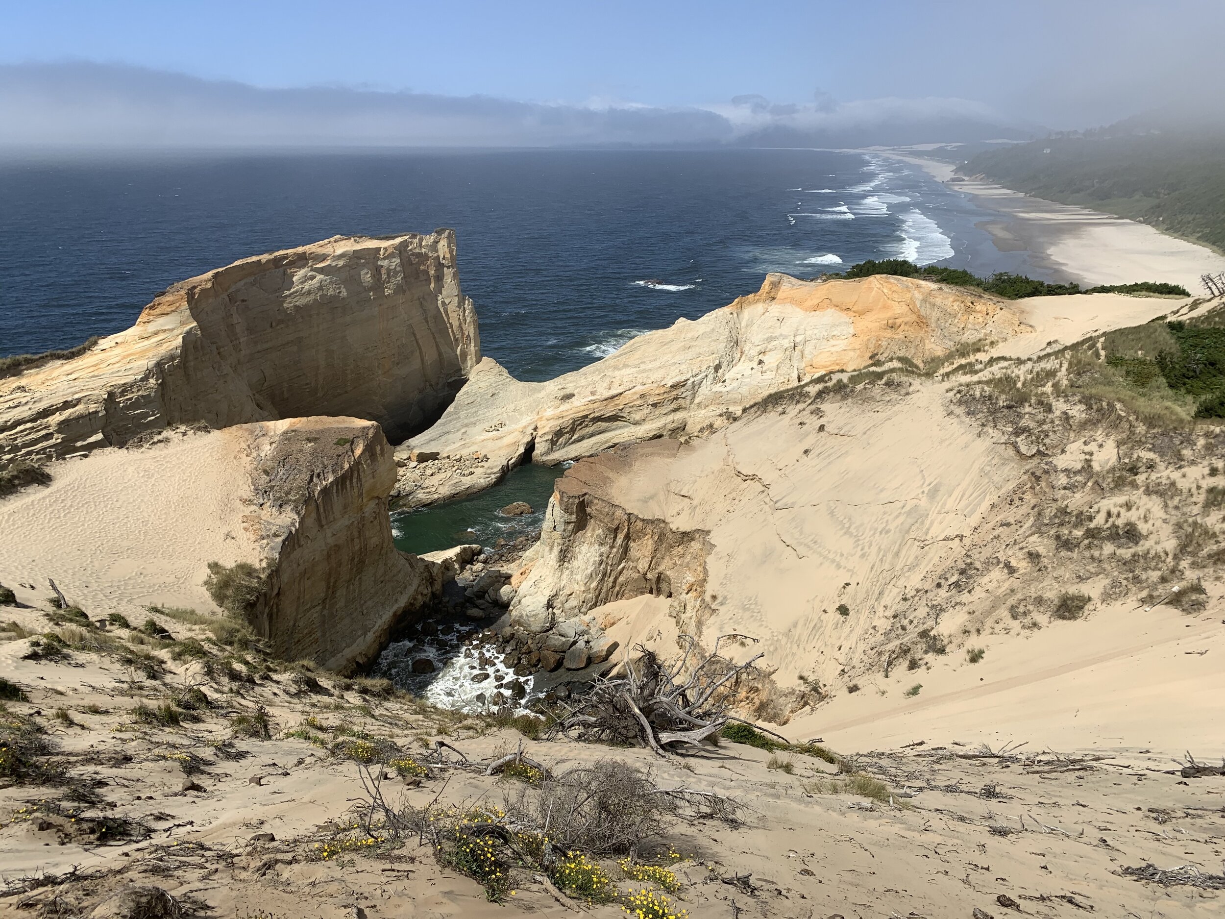  At Pacific City Beach, the rocks and sand dunes were the biggest we’d seen. Craig and Curtis climbed up the dune to look out over the ocean. Craig took this photo looking north up the coast. The scene of people going up and down the enormous dune wa