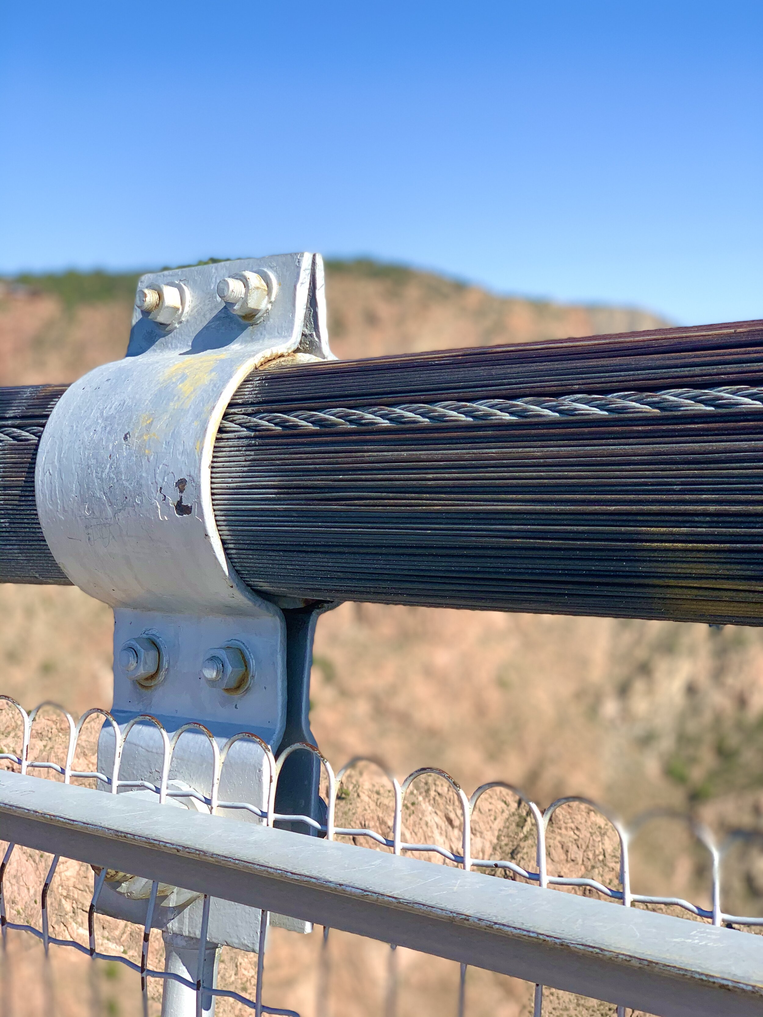  Royal Gorge Bridge is 1,260 feet long and 18’ wide.  There are 2,100 strands of galvanized wire in the 300 tons of cables suspending the bridge, 1,000 tons of steel in the bridge floor, and the weight capacity of the bridge is over 2 million pounds!