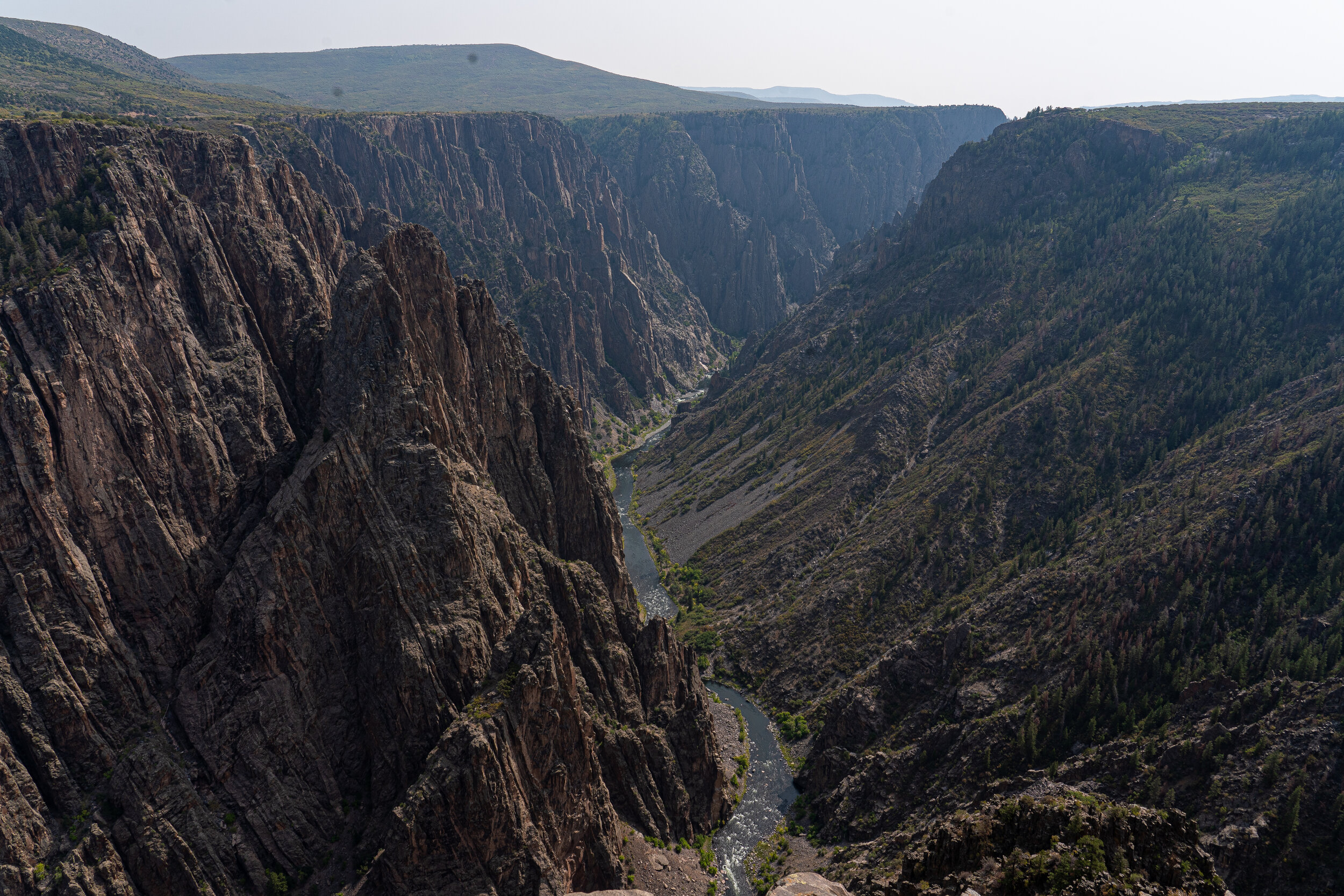  The Black Canyon is so named because its steepness makes it difficult for sunlight to penetrate into its depths. As a result, the canyon is often shadowed, causing the rocky walls to appear black. The right side of the canyon is more worn away than 