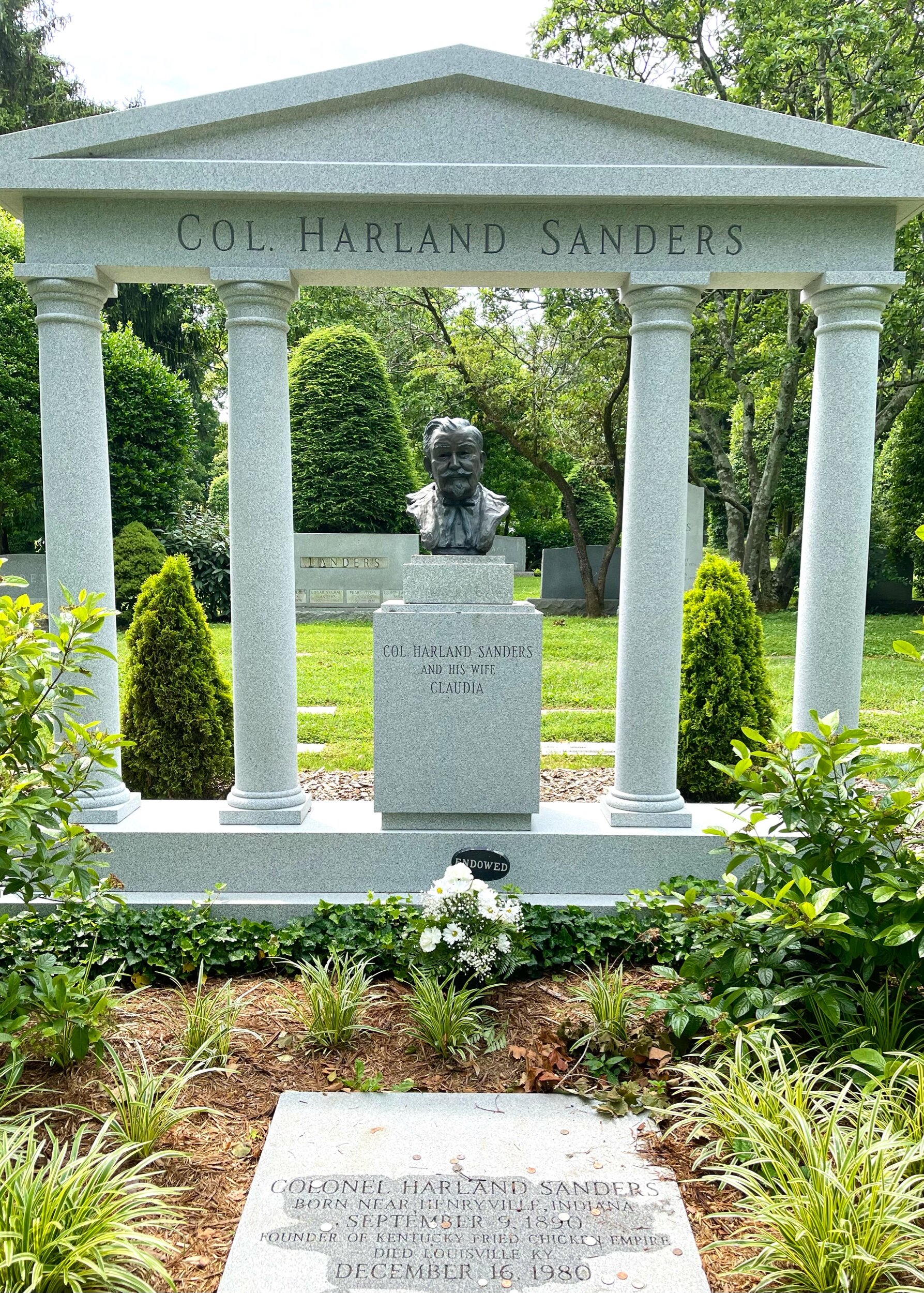  The sculpture overlooking  Colonel Harland Sanders’  grave was sculpted by Colonel Sanders’ daughter, Margaret. Margaret and her son, also named Harland, are buried beside her father. Harland’s gravestone beside his grandfather reads, “I sure had fu