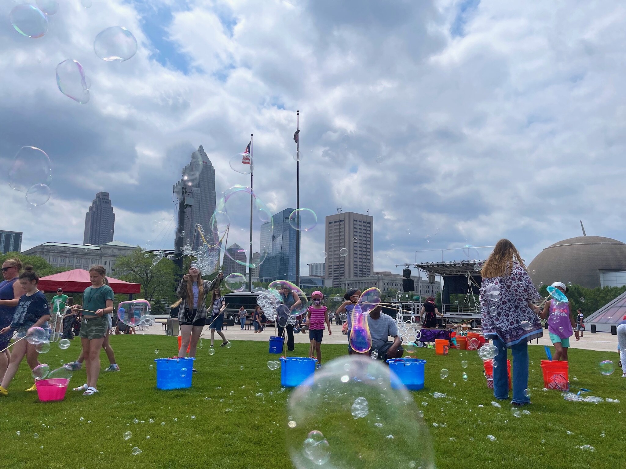  Outside the  Rock and Roll Hall of Fame  in downtown  Cleveland, Ohio.  This place was hopping on the day of our visit. A young group of students from the School of Rock in Cleveland were performing and across the lawn, the bubbles were a-flyin’. 