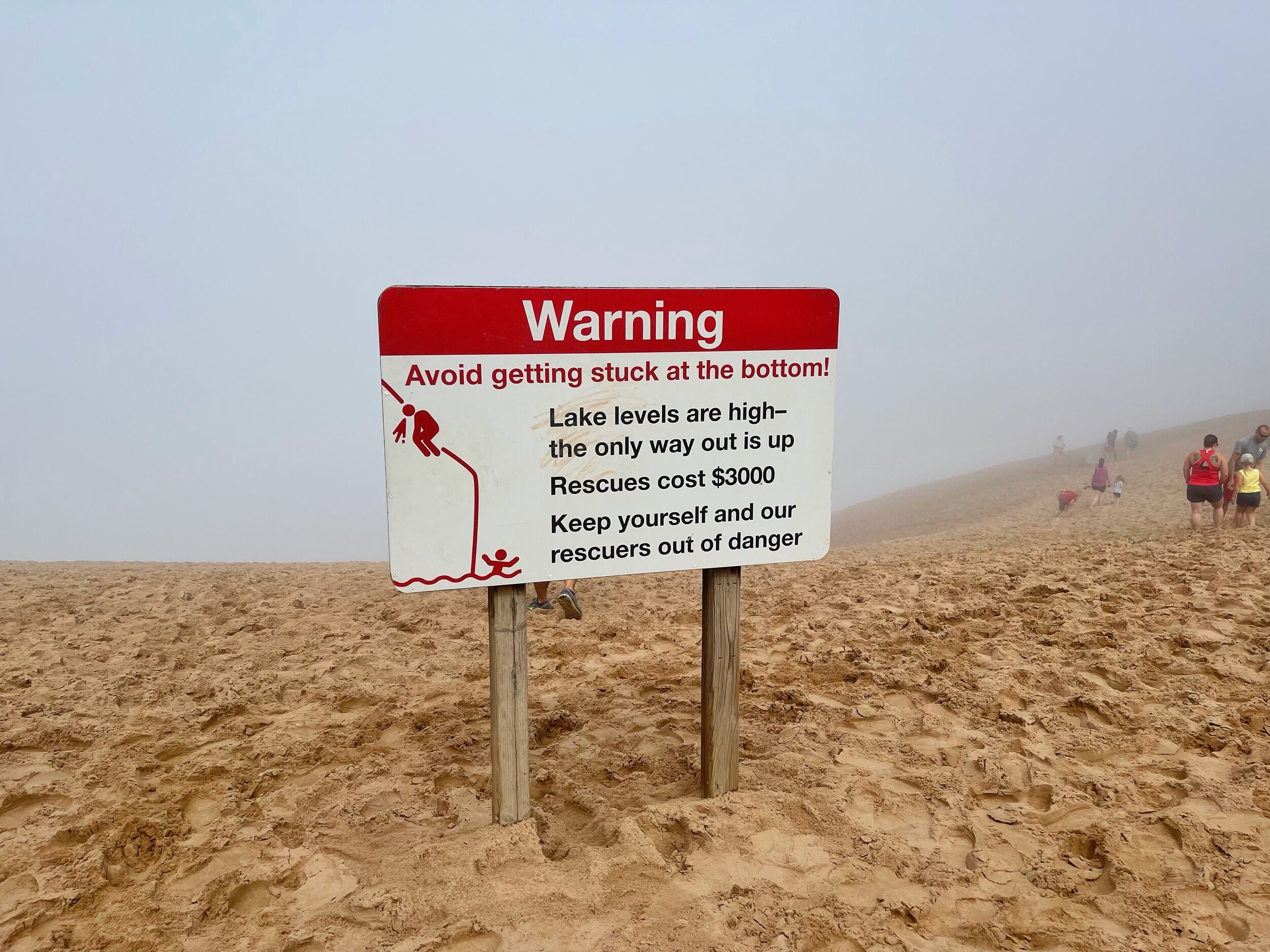  A section of the dunes at Sleeping Bear are 450 feet straight down to the water’s edge. Even with this warning, we watched a continuous stream of people skip down into the thick fog. Much like walking up an escalator that is going down; climbing bac