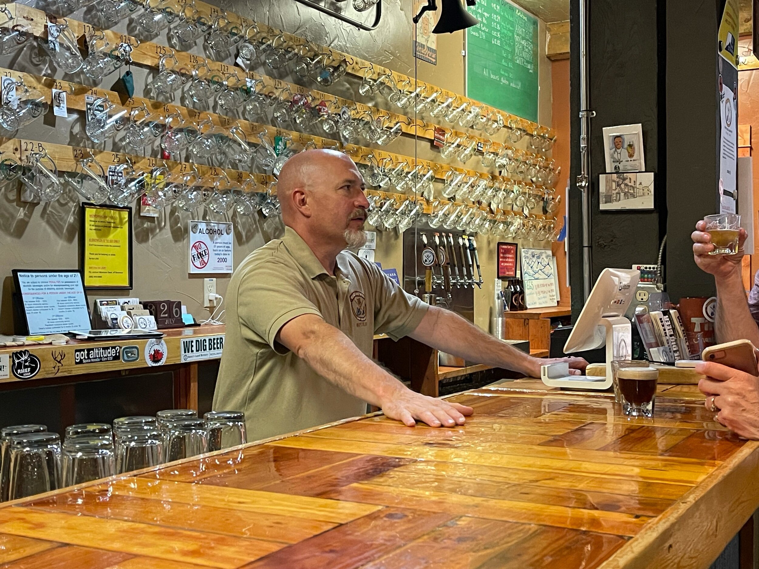  This is Chuck, the owner of  Quarry Brewery . With great pride he told us more about  the town of Butte and explained his Mug Club to us. On the wall are the mugs of 200 of his best patrons. Each cup hangs on a numbered peg, and he knows every custo