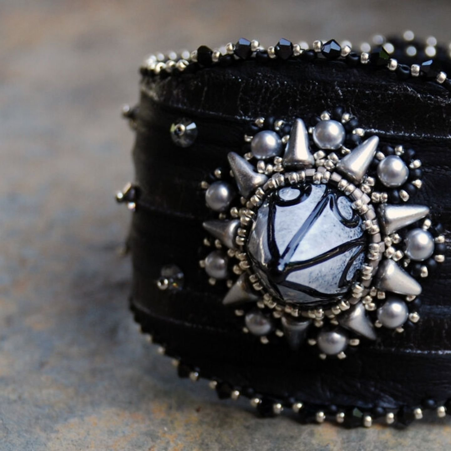 This rockin&rsquo; cuff is made of ultra soft leather, the stripes are slightly variegated from black to silver. The spike focal is handmade lampwork glass by artist Patricia Larson.
.
#leathercuff
#rebelrebel 
#handmade 
#ooakjewelry 
#spikejewelry
