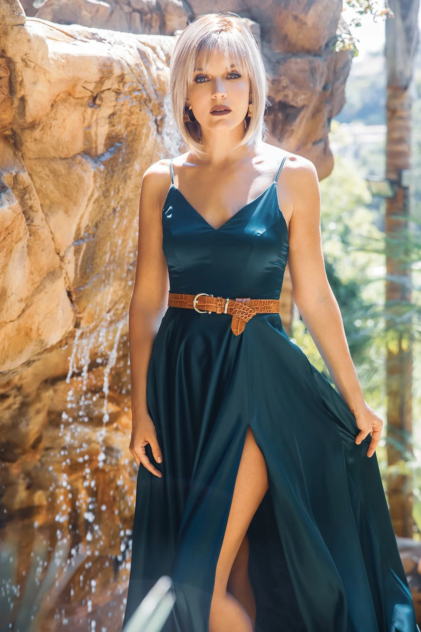 A woman in a green dress wearing the Alva wig by Noriko