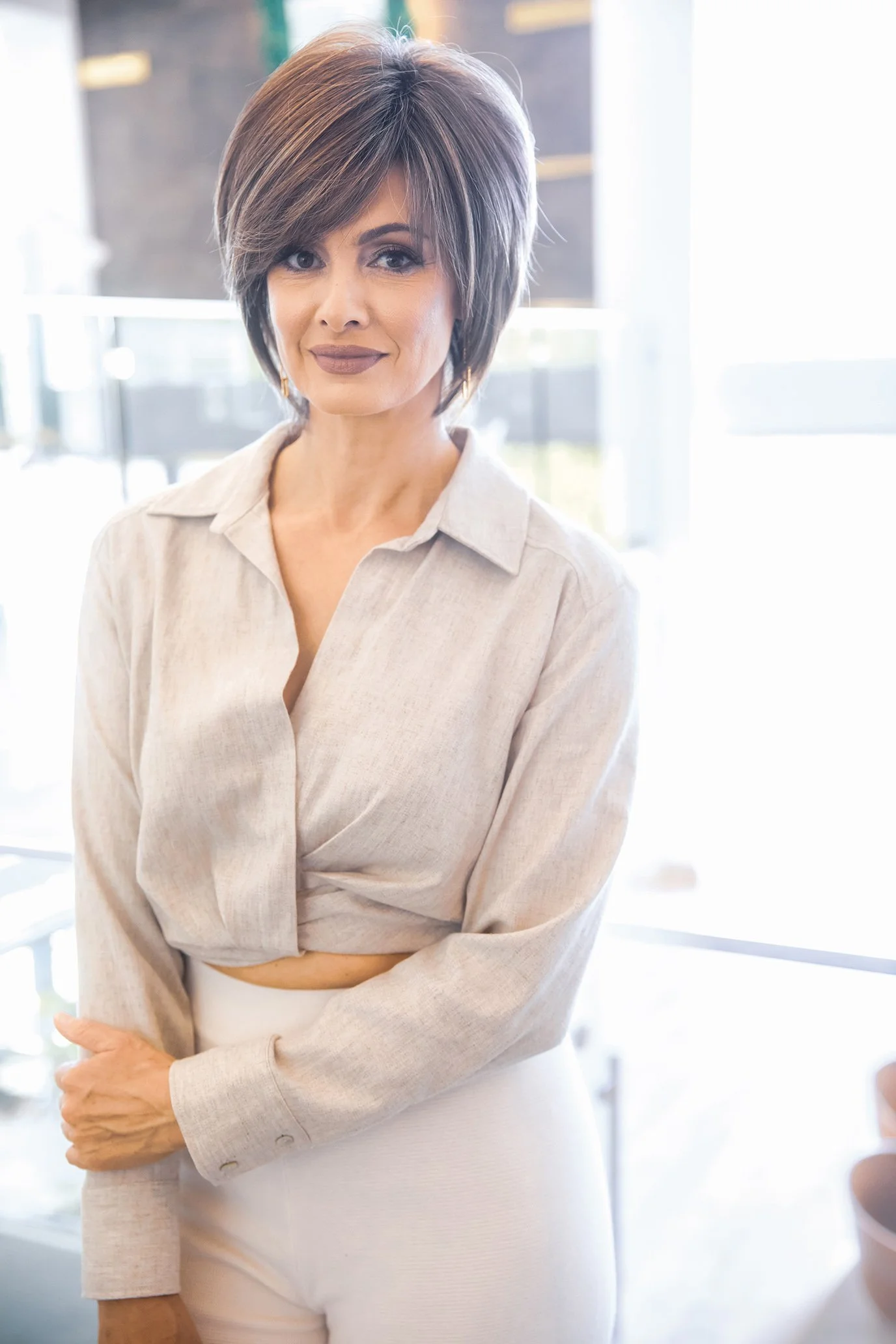 a woman standing and smiling at the camera
