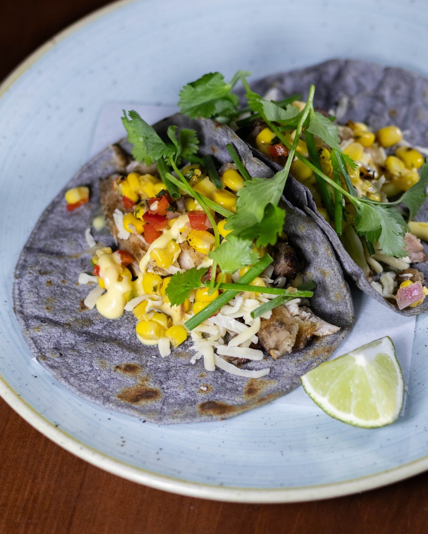 🌮 New Taco of the Moment 🌮

We're fully embracing backyard barbecue season with this woodfire-grilled chicken taco, available now in St. Paul! Topped with corn pico de gallo, chile crema, chives &amp; cilantro on a blue corn tortilla, this smoky ta