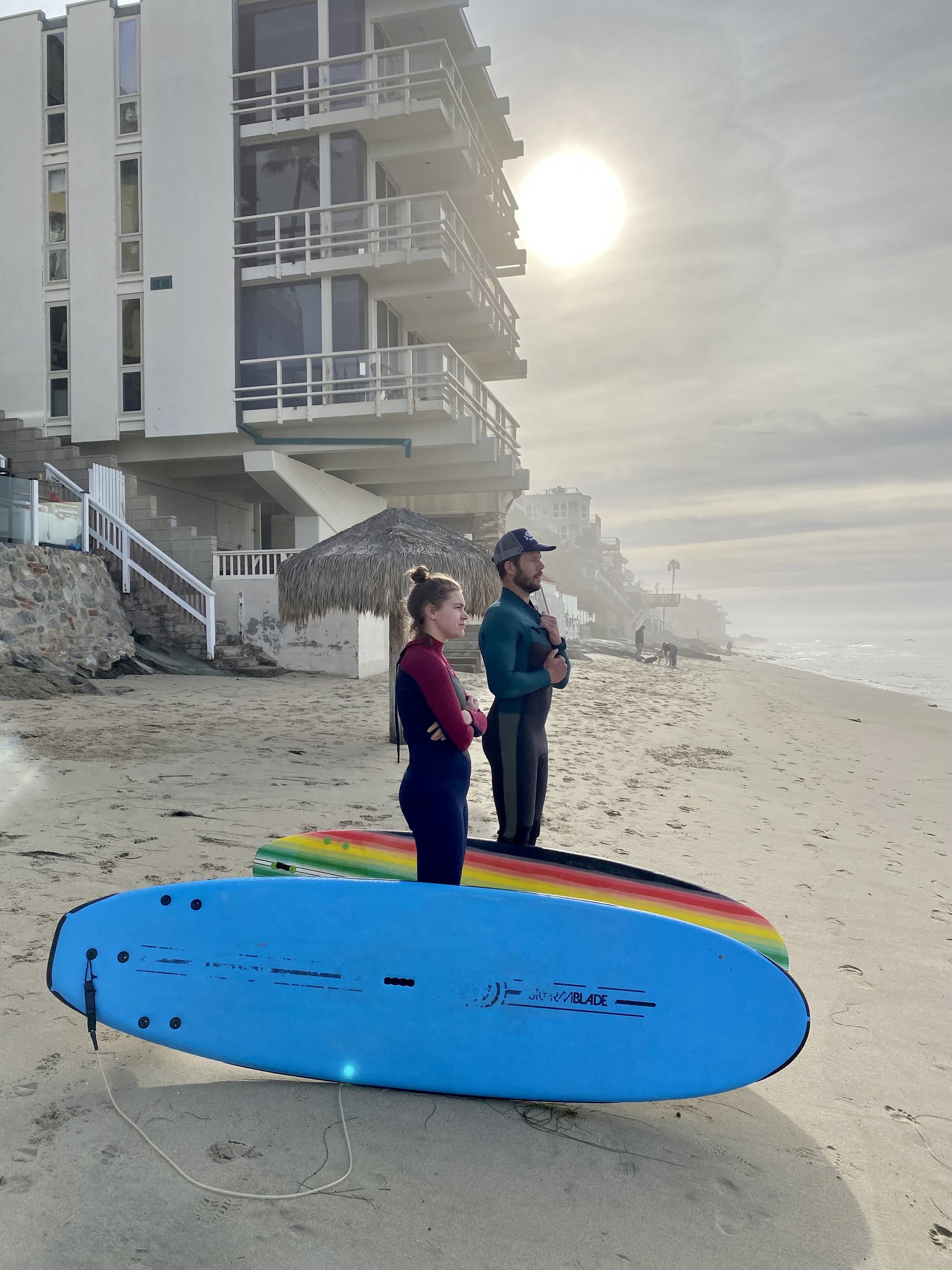 surf instructor and student observing ocean conditions from the sand.JPG