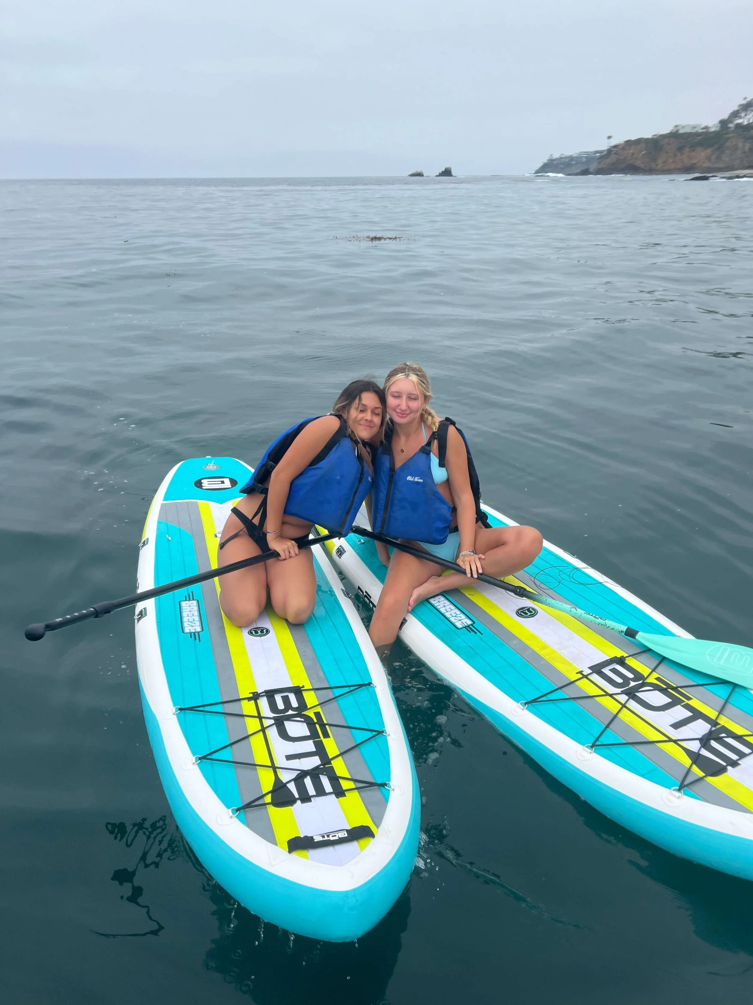 Two friends seated on their paddle boards in laguna beach.jpg