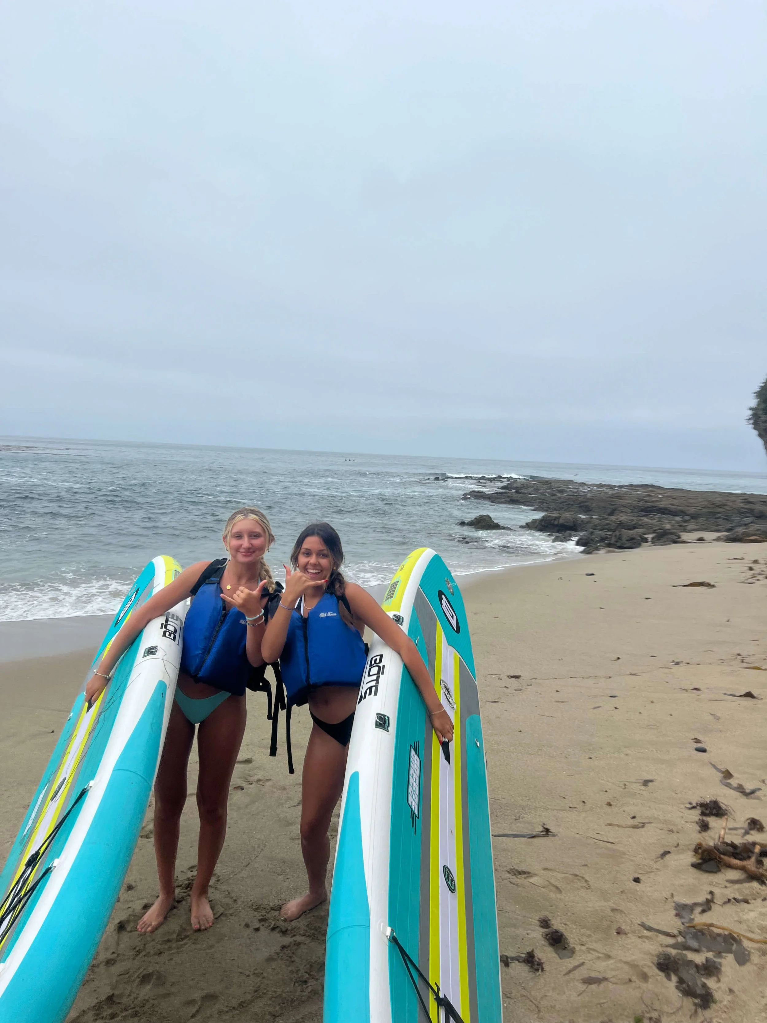 Two girls holding paddle boards in laguna beach.jpg