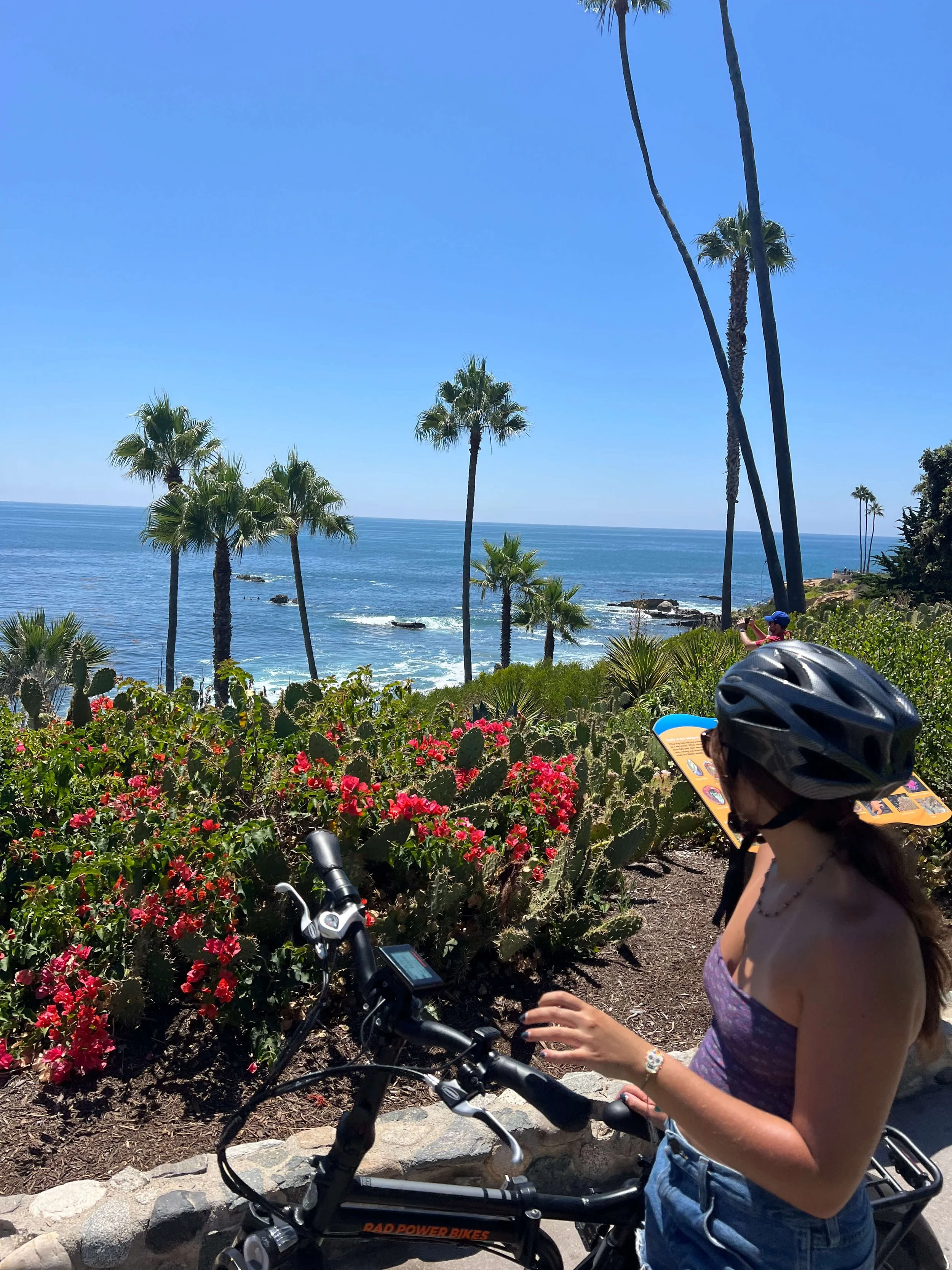 Girl on e-bike sitting in front of Heisler park.jpg