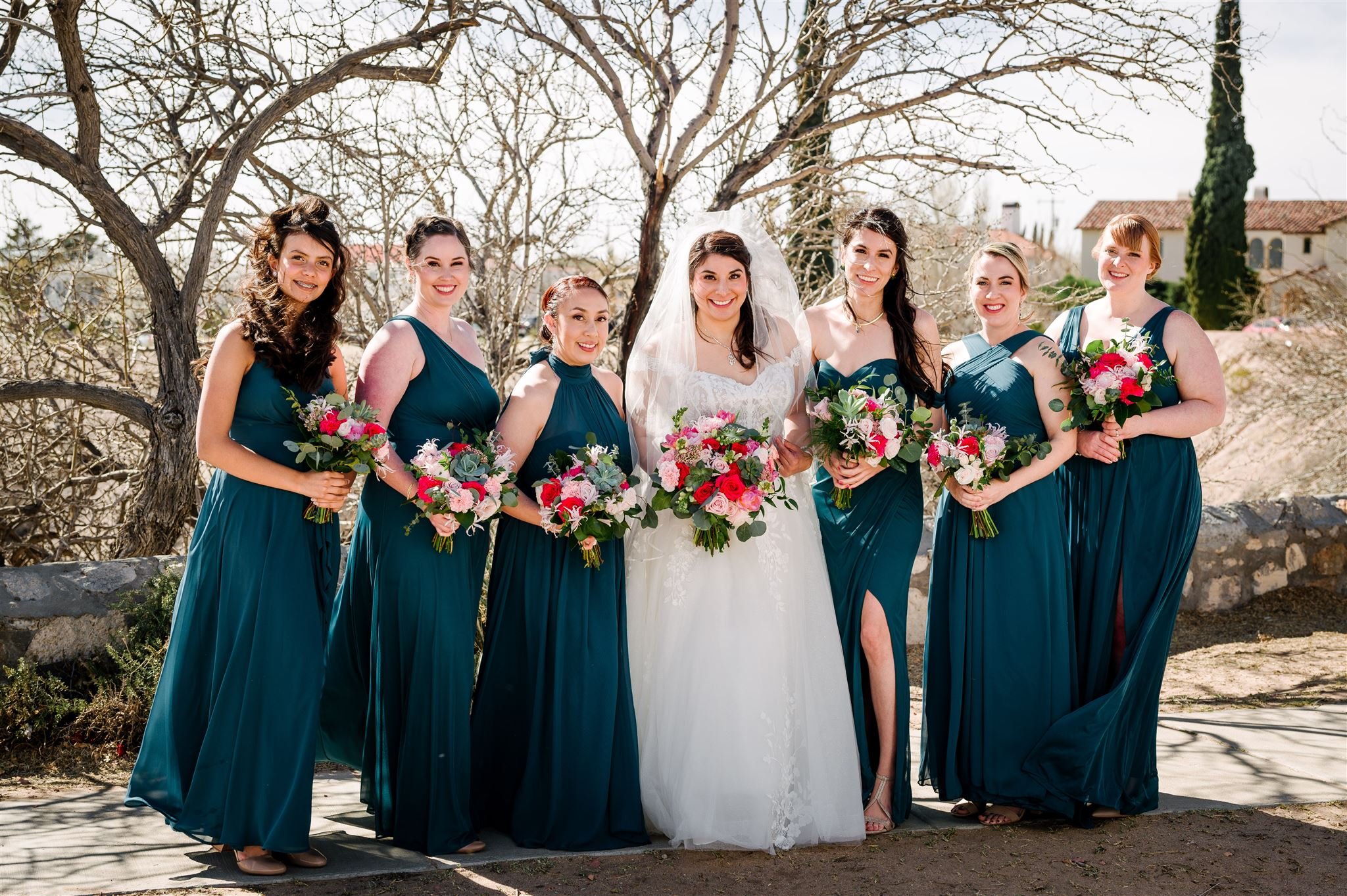 Photo by Stephane LeMaire of bride and bridesmaids with bright pink floral bouquets and succulents