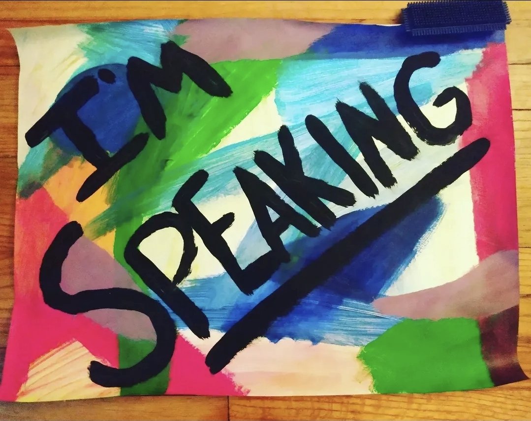 Colorful abstract background with the words 'Stop Spreading' written in bold black letters.