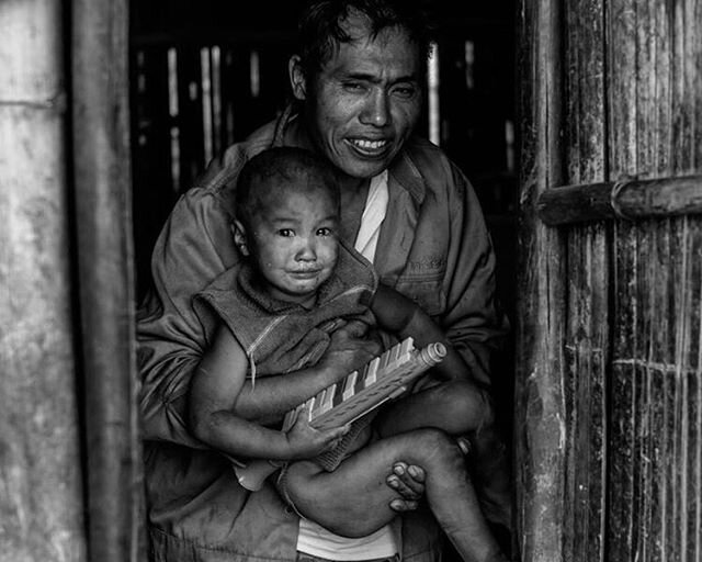 Our third place photo, shot by Leon Chang describes his photo like this: &quot;This photograph illustrates a Lisu father holding his youngest son. In fact, there are 18 more children in this family that are not present in this photograph. There are m