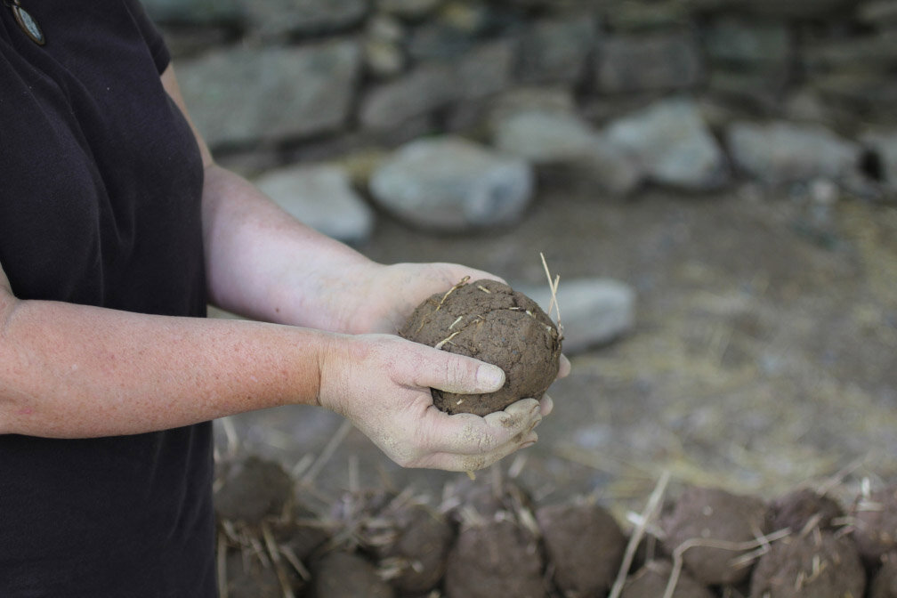  A cob ball about to be added to the wall (L.B.) 