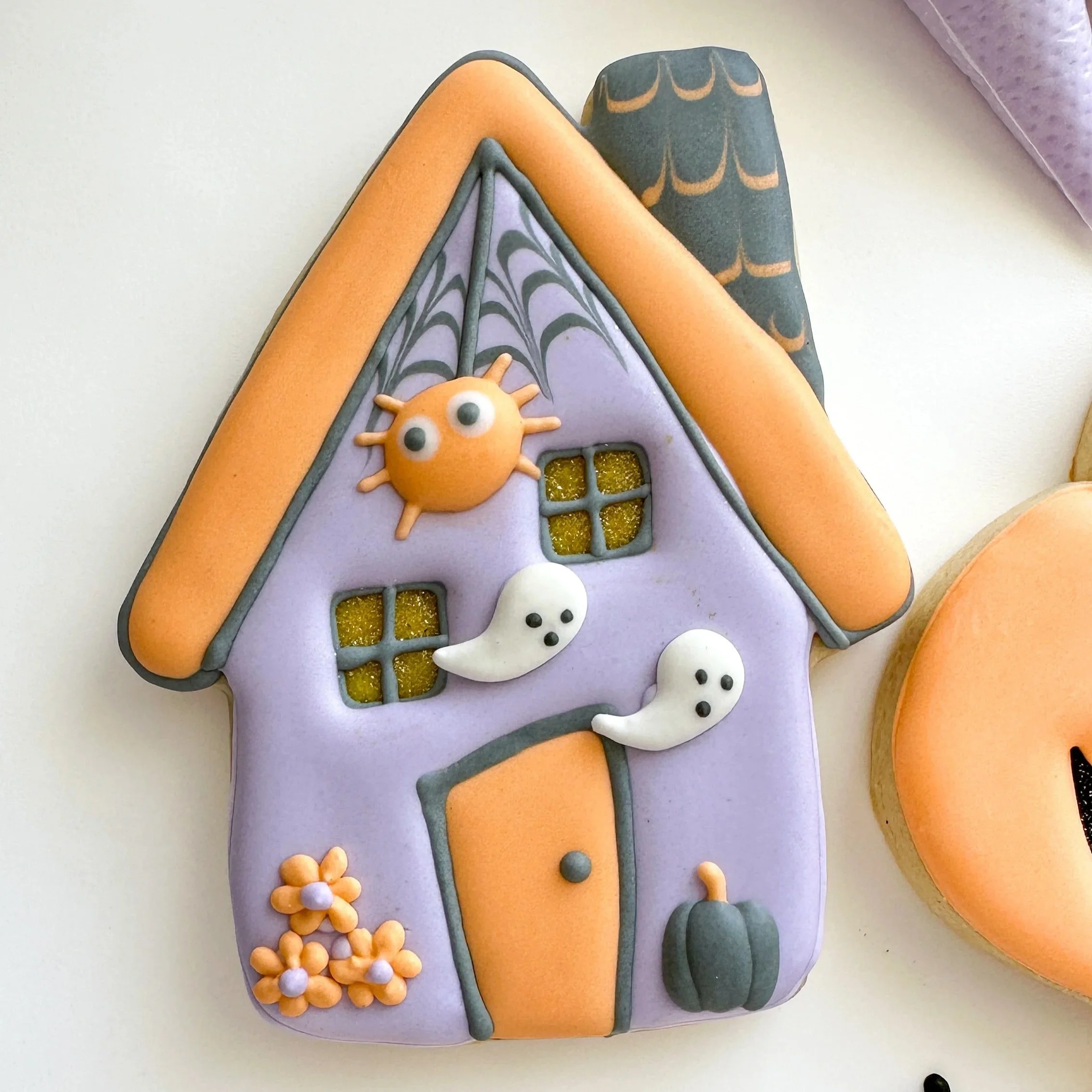 Purple and orange haunted house decorated cookie