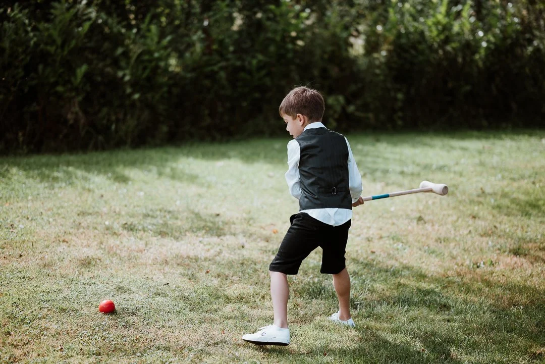 Boy plays croquet at the Orchard Garden at Dairyhouse Farm