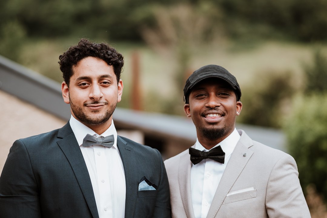Two make wedding guests smile for the camera