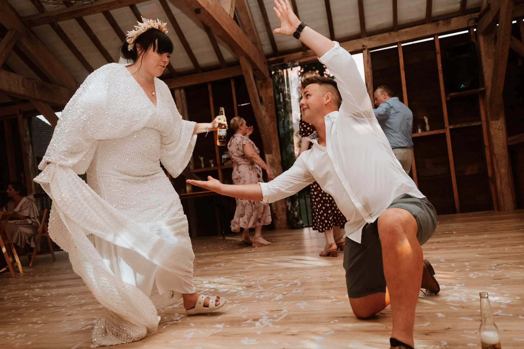 Bride and wedding guest throw some funny shapes on the dance floor