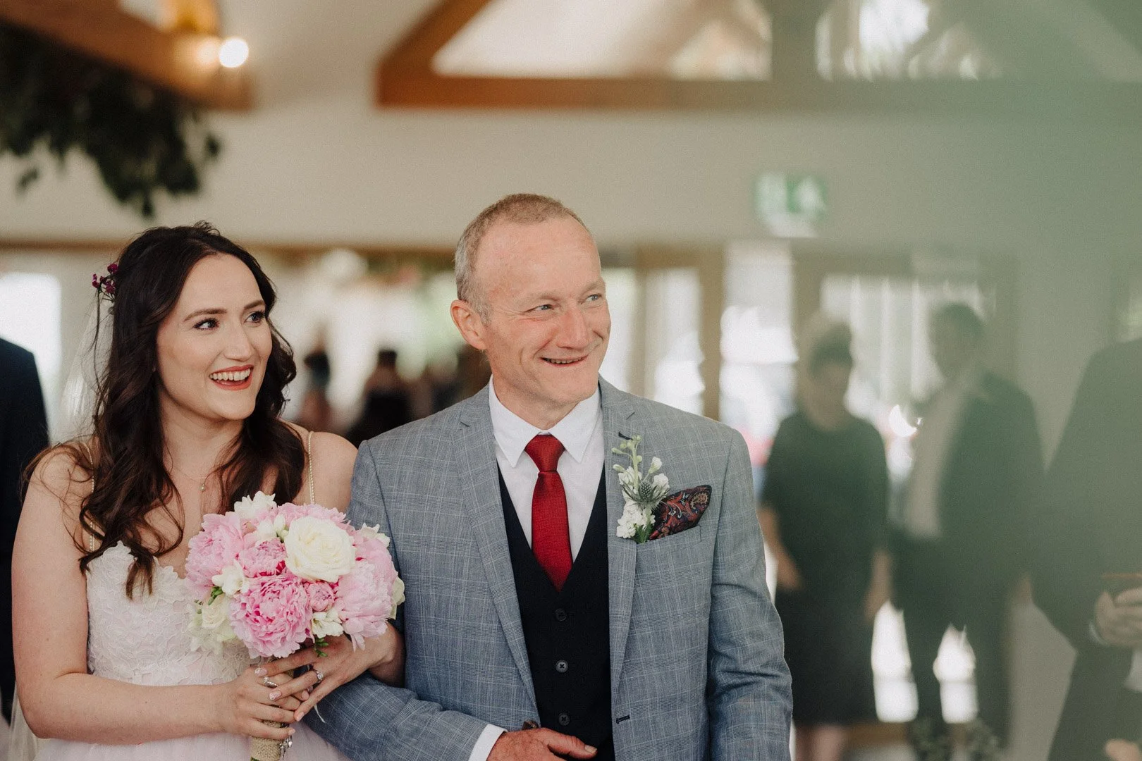 bride is escorted by her father down the aisle at BlithfieldLakeside Barns
