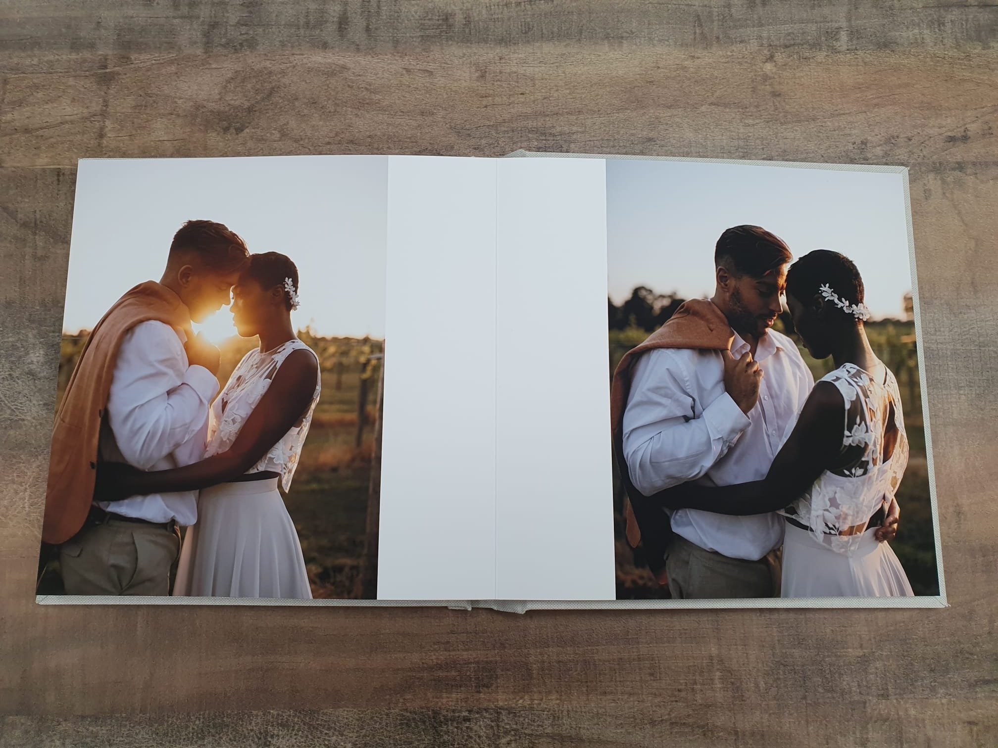  fine art wedding album displayed on a wooden table 