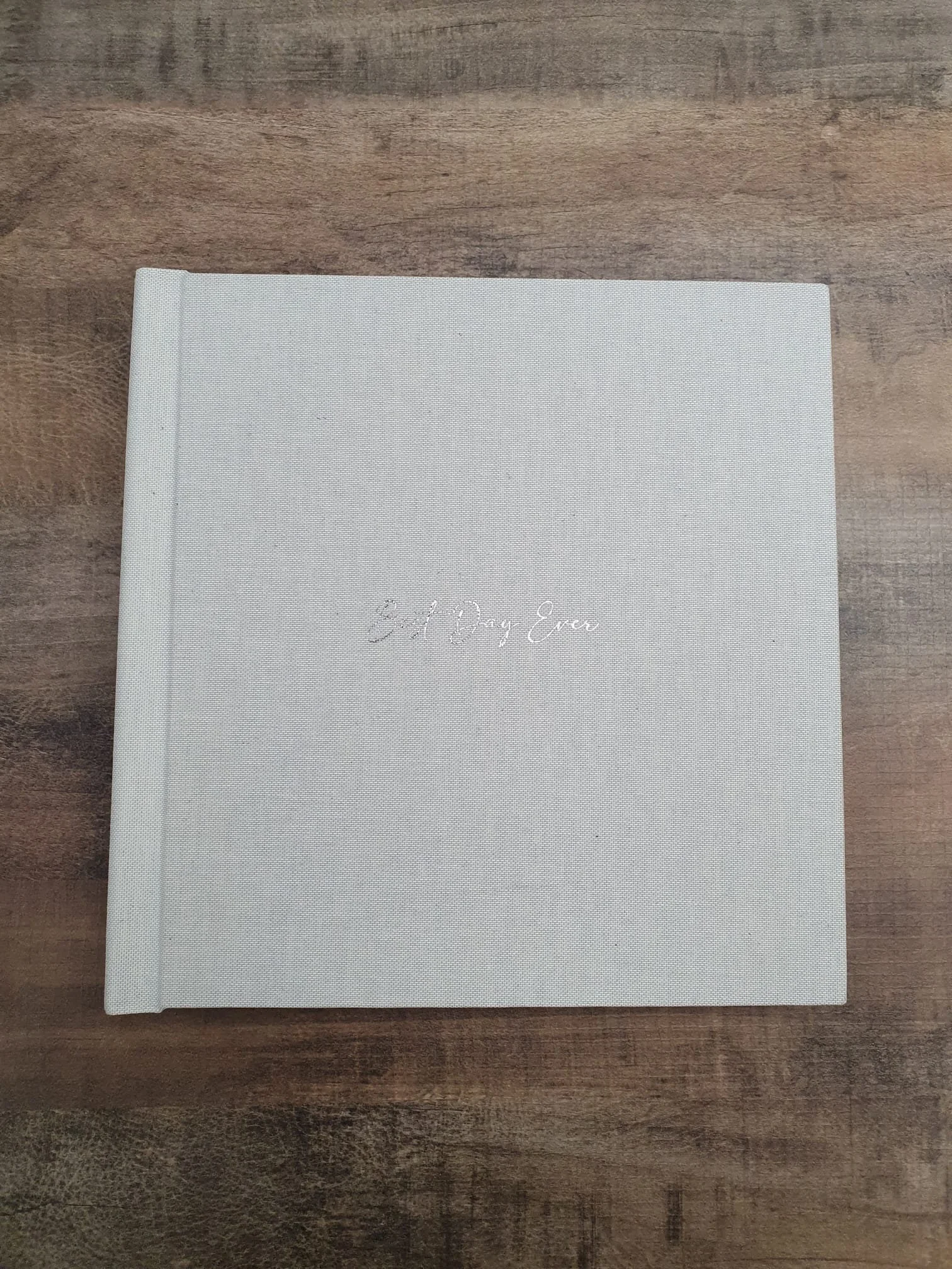  fine art wedding album displayed on a wooden table 