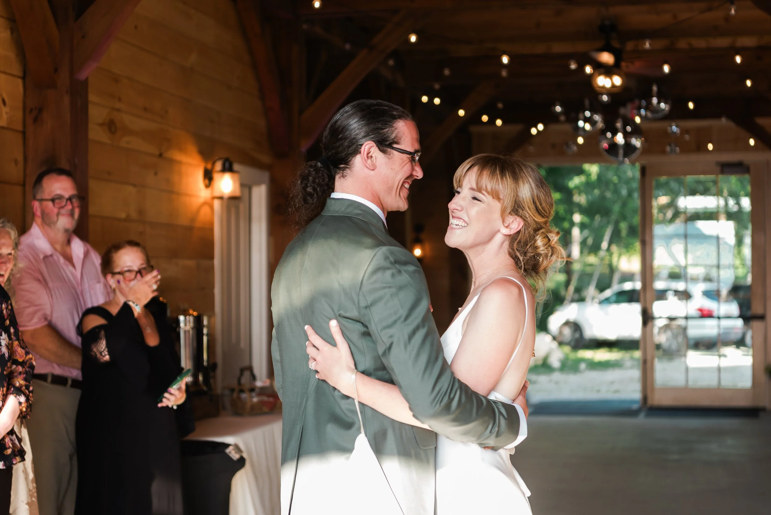 Newlyweds share a laugh during their first dance at their New Hampshire wedding venue.