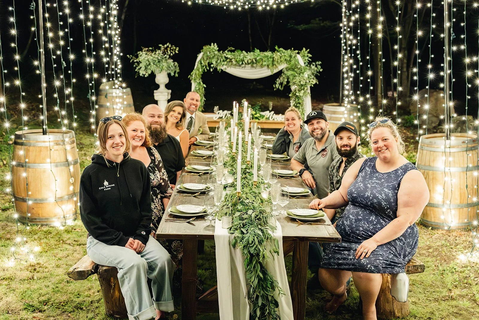 The wedding pros behind this styled shoot all sitting around the decorated reception table.