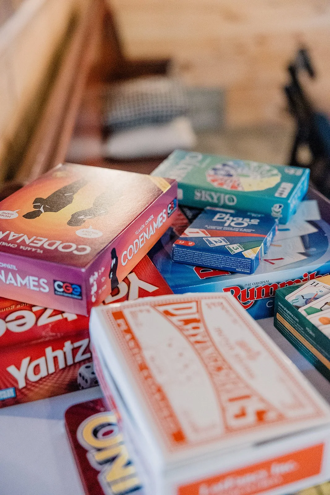 A pile of classic board games were placed on each table after dinner during this garden wedding.