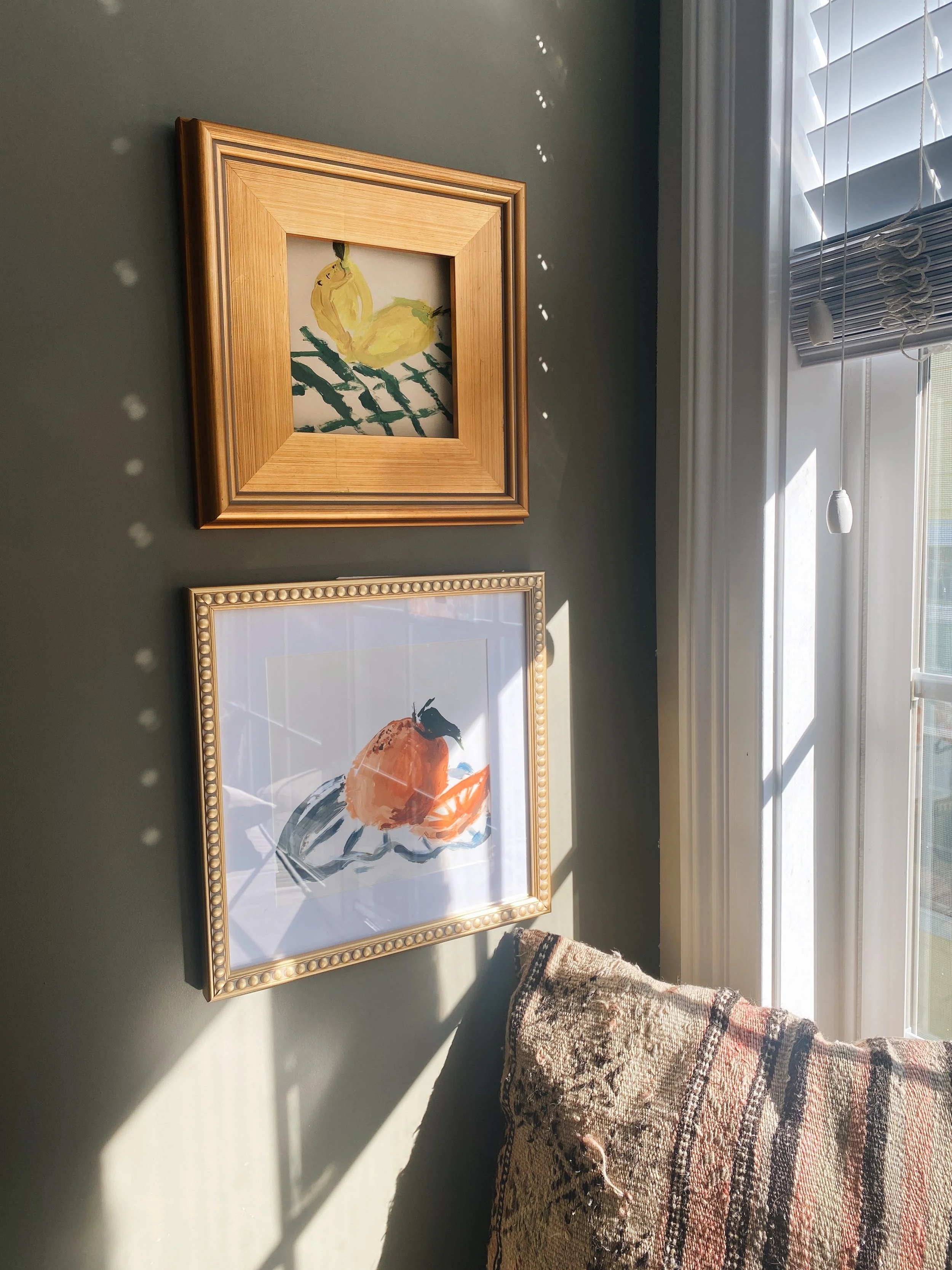 premium reproduction print of an orange on plate painted in acrylics. hanging on wall framed.