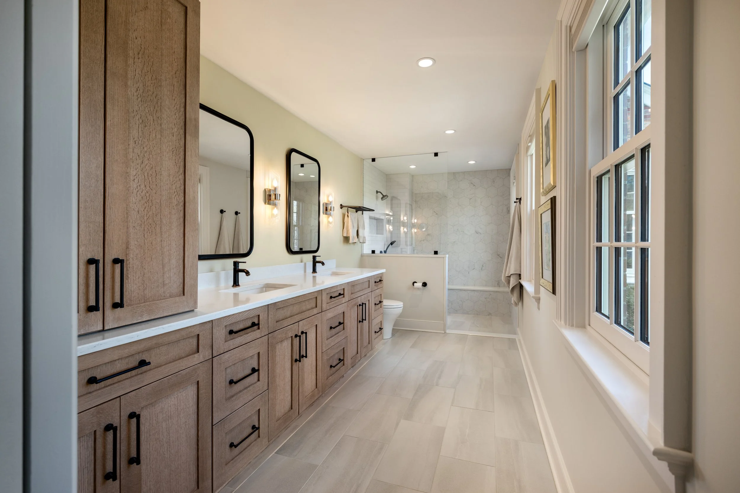 modern primary bathroom with black hardware and neutral colors