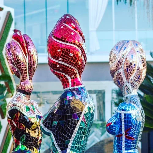 Colorful mosaic sculptures of female figures in the sculpture garden at Westfield UTC in La Jolla.