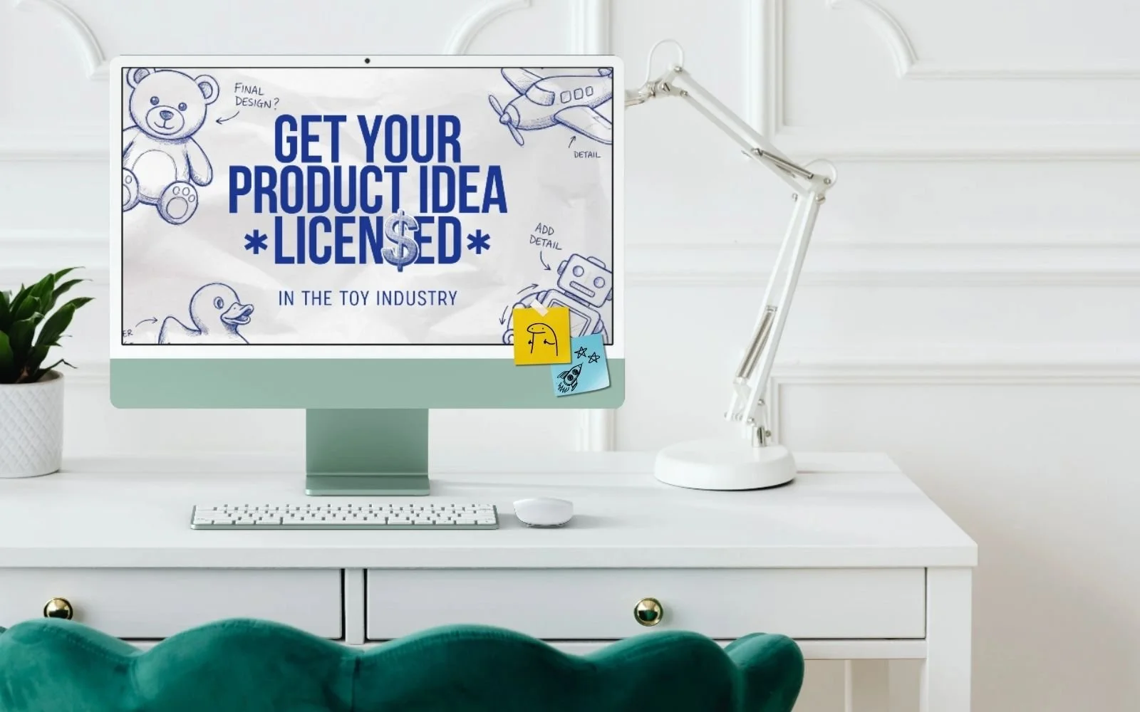 White computer monitor on a white desk displaying an advertisement for licensing toy product ideas, with doodles of a teddy bear, airplane, duck, and robot, and sticky notes attached to the bottom.