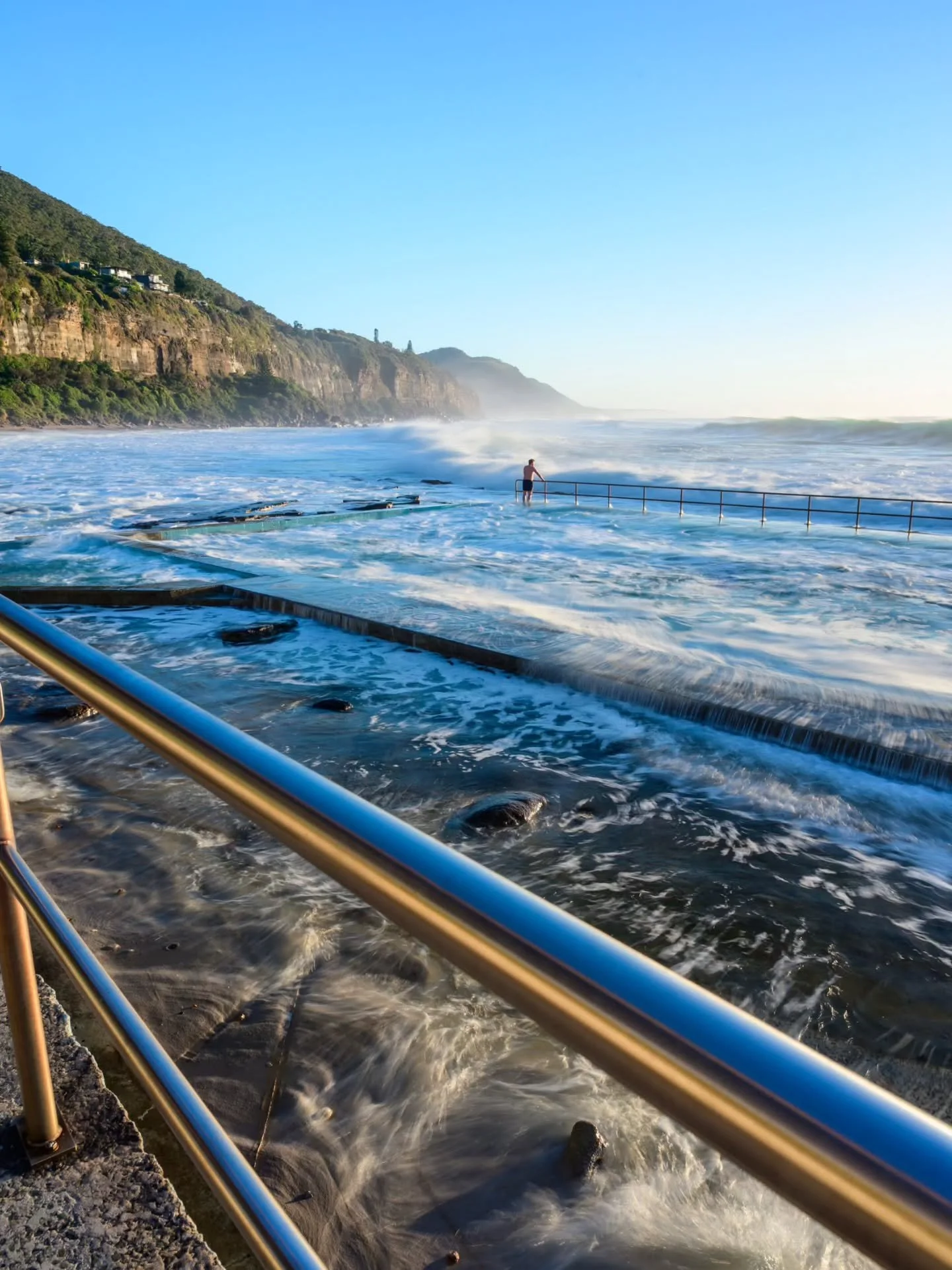 The first person to brave the washing machine that was Coalcliff pool last Friday. He started by walking along the pool egde to the railing and letting a few waves smash into him before jumping in and enjoying a not so relaxing swim.

See more at www