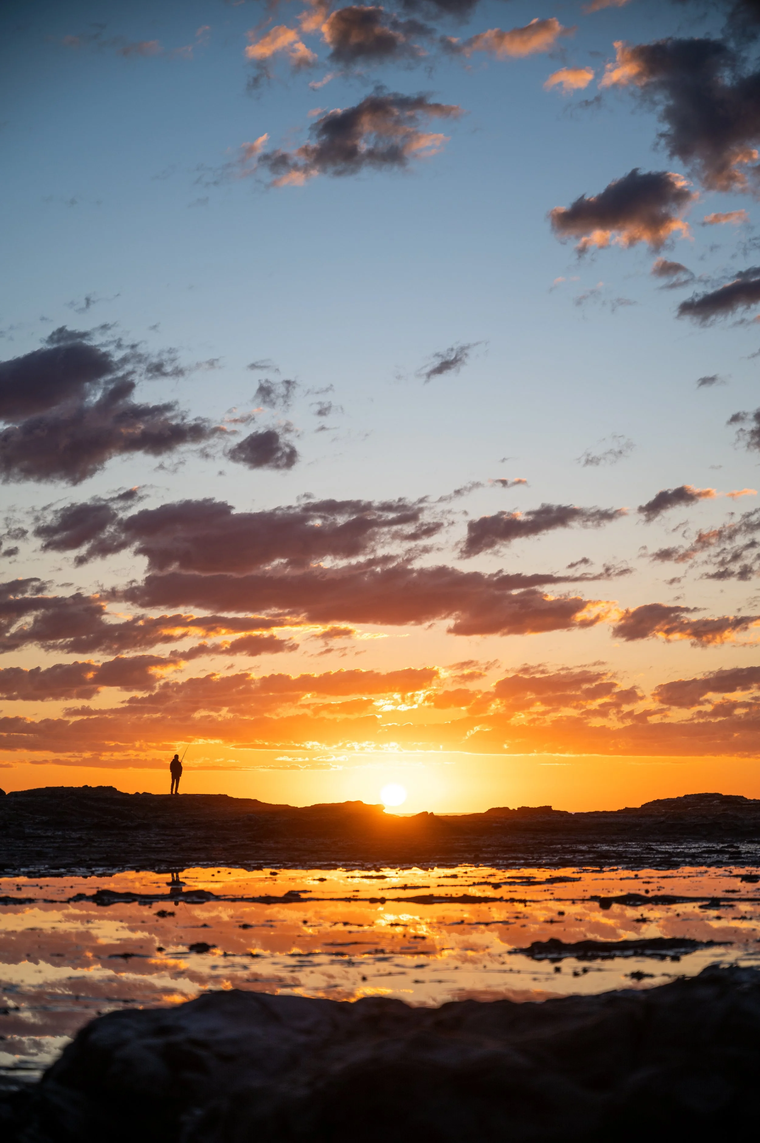 FishermanReflectedAtSunrise.jpg