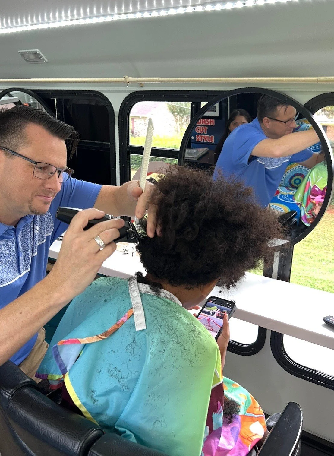 Mark cutting hair on bus.jpeg