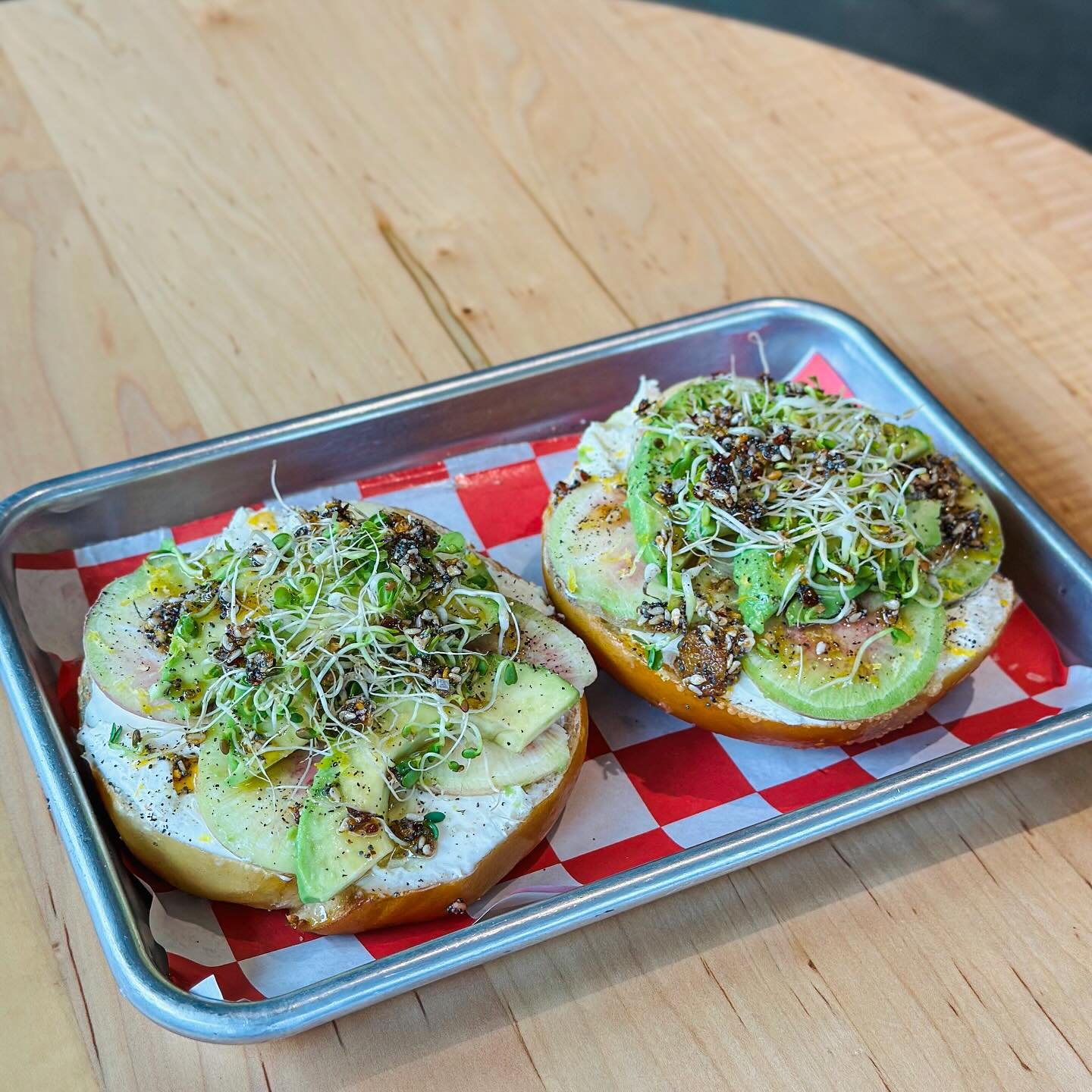 🚨 NEW BAGEL SPECIAL 🚨- The R.A.D. Bagel AKA the Really Awesome Delicious has a base layer of schmear and is then topped with thinly sliced watermelon RADish, sliced avocado, @bloomsburyfarm hot n spicy sprouts, our house made Everything Spice Chili