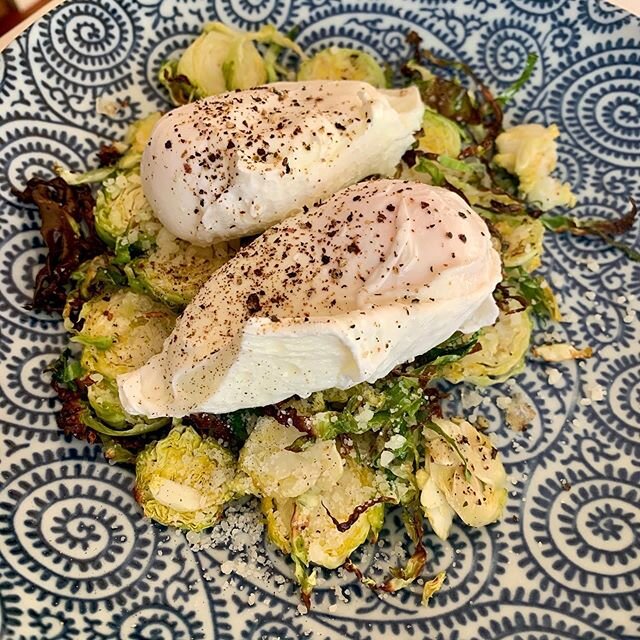 Delicious healthy lunch. Roasted brussel sprouts (thinly sliced drizzled with olive oil and some sea salt and roasted till brown and toasty) poached eggs and a sprinkle of Parmesan cheese #brusselsprouts #poachedeggs #roastedvegetables #healthylunch 