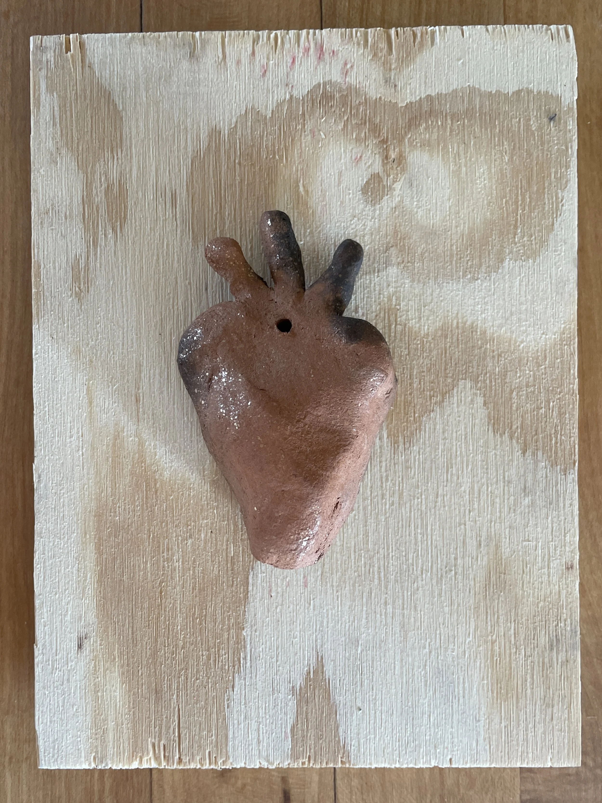milagro 17, 2023 
New Mexican red micaceous clay and primitive fire, plywood, 5 x 7 inches, $150
