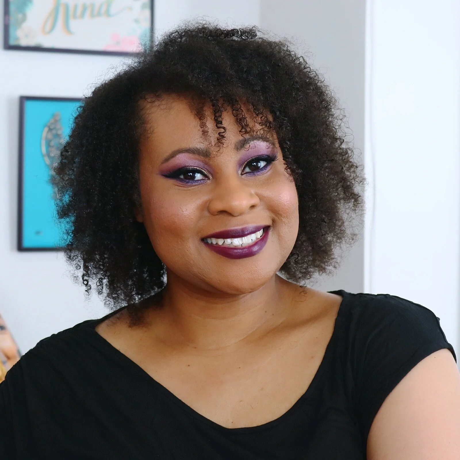 black woman with dark purple Avon makeup avon rep