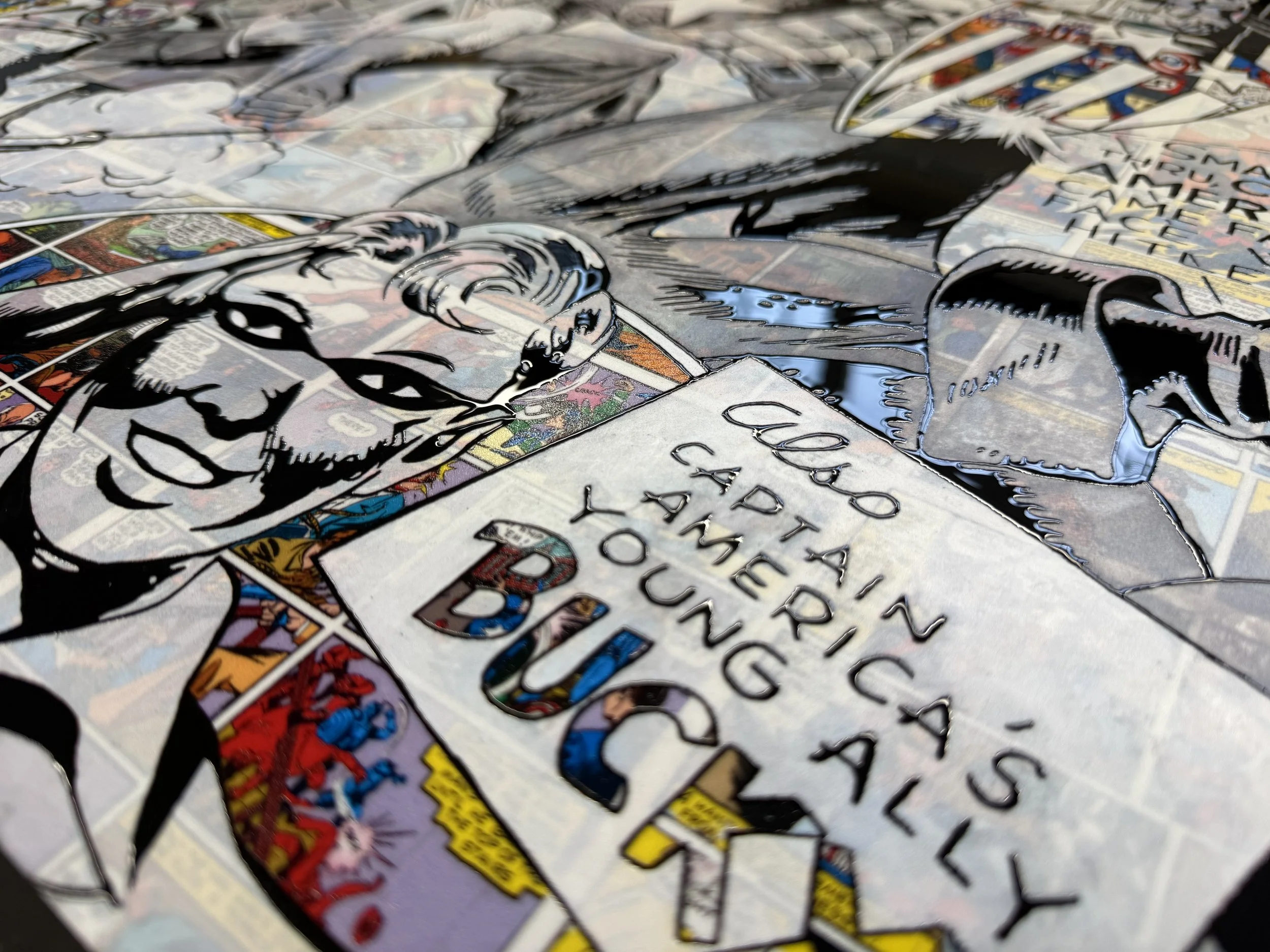 Close-up of a comic book page with artwork of a man writing at a desk and speech bubbles with text.