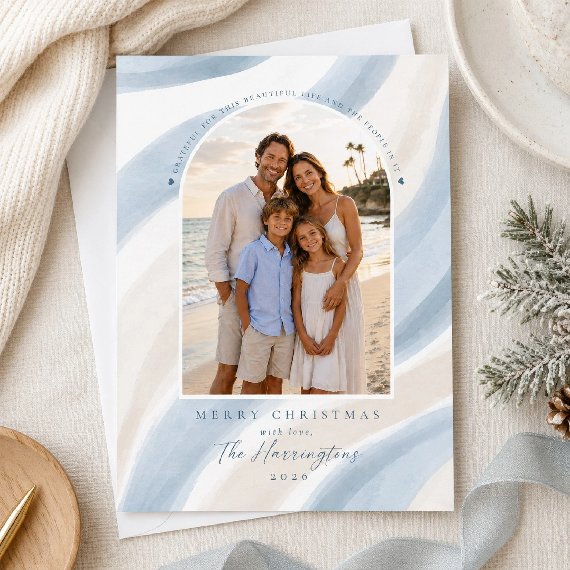 Whether Christmas means bare feet on the beach or boots in the snow, I wanted this card to feel at home in both.

Soft watercolor blues move somewhere between ocean tides and a frosty winter morning, framing your favorite family photo without leaning